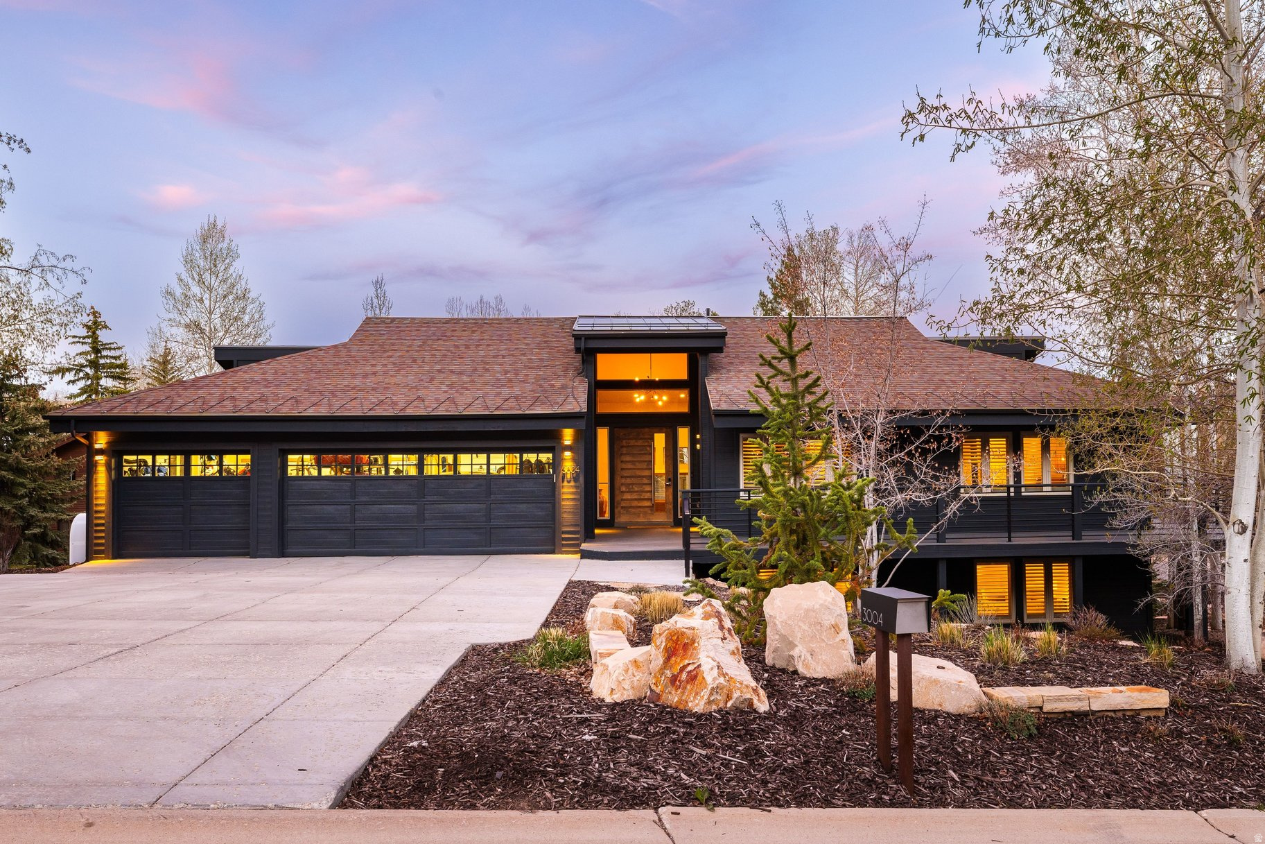 Experience effortless Park City living in this stylishly updated Park Meadows home with ski run views and exceptional indoor-outdoor flow. Designed for main-level living, the light-filled great room features soaring 14-foot ceilings and walls of glass that frame the mountains. The chef's kitchen, complete with Thermador appliances, double dishwashers, wine refrigeration, and a walk-in pantry, opens seamlessly to an inviting den and expansive deck, ideal for entertaining or quiet evenings under the stars. The main-level primary suite offers Deer Valley views, a fireplace, spa-like bath, and a generous closet with integrated workspace. Downstairs, four bedrooms, a wet bar, and gathering spaces create the perfect setting for hosting family and guests. Enjoy a beautifully landscaped, private yard with bocce court, firepit, and fenced dog run. Central air, a flat driveway, and an oversized 3-car garage complete this turnkey retreat just minutes from skiing, trails, and Historic Main Street.