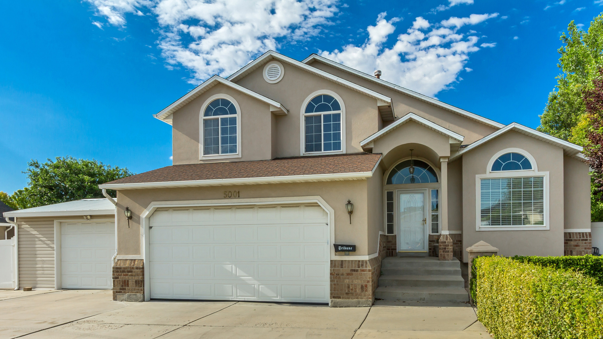 This West Jordan home is a rare find that offers five total garage spaces, RV parking, a detached garage/shop, a studio shed, and a fully remodeled kitchen. Inside, the kitchen features a gas stove, stainless steel appliances, and granite countertops. The primary bedroom includes an en suite and a walk-in closet. Additional highlights include a separate laundry room, a fully finished basement with a second living room prewired and built-in for home theater, a Culligan water softener, and a 50-gallon water heater. Outside, a large custom covered patio extends off the back of the home and includes an elevated full-size refrigerator, perfect for outdoor entertaining. The third-car garage has double doors that open from both sides for drive-through access. The detached garage/shop measures 23'4" x 23'4" and features an oversized door measuring 15'8" wide x 11'5" tall. And a studio shed measuring 10'6" x 11'8" with power and lighting. Located minutes from Jordan Landing, retail stores, and grocery stores, this home also offers quick access to Mountain View Corridor and Bangerter Highway, putting shopping, dining, and commuting routes all close to home.