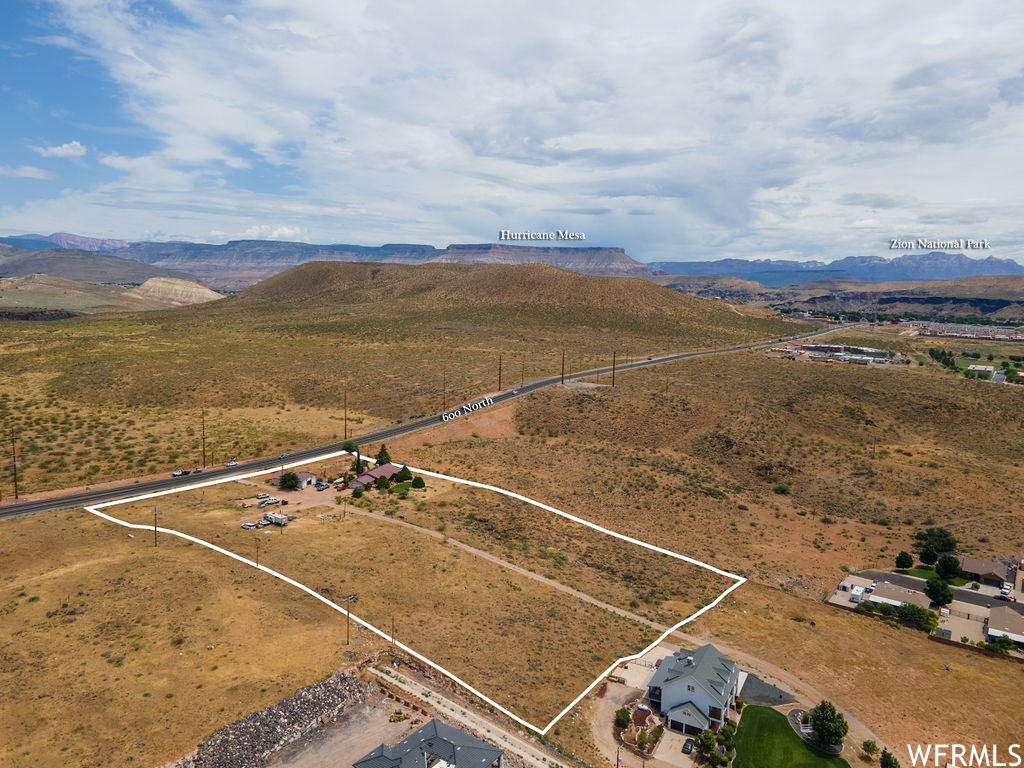 Attention Developers!! Don't miss this incredible development opportunity for a mixed-use development on just under13 acres on Hurricane's Prime Commercial Corridor, 600 North.   This 5.46 acre portion just received a re-zone to Planned Commercial. The town approved of a mixed use of 67% commercial and 33% residential use. Combine it with the two properties next door and create a one-of-a-kind destination with both commercial and multi-housing residential projects. Additionally, the proximity to two other available and adjacent parcels opens up the potential for a mixed-use development spanning nearly 13 acres.   Current Zoning allows for retail spaces, restaurants, hotels, bed and breakfast Inn's, and more! The land comes with the bonus of an existing 1907 sq ft home which features 3 bedrooms, 2.5 bathrooms, a spacious kitchen, ample living area, an 1858 sq. ft garage and stunning outdoor spaces. The surrounding landscape is picturesque with scenic views and mature trees. The property's location and size make this a unique opportunity to bring a creative new development to the Town of Hurricane. Please call to discuss the utilities and access information for this whole development possibility. SELLER FINANCING AVAILABLE!!