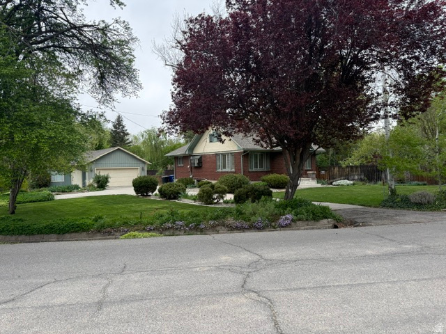 Located on a beautiful .29-acre lot in a highly desirable Salt Lake neighborhood, this classic brick bungalow offers a rare opportunity to renovate, restore, or build in an exceptional setting. Surrounded by mature trees and established landscaping, the property features strong curb appeal, mountain views, and a detached 2-car garage with additional flex space. The home retains vintage character and functional living space, but much of the value is in the generous lot, desirable location, and future potential. Whether you are looking for a home to update over time or a premium homesite in a sought-after area, this is a unique opportunity with endless possibilities. 1 share of Holladay Company Water is included in the purchase. Valued at $10,000, this company share provides 60,000 gallons of free culinary water per year. Square footage figures are provided as a courtesy estimate only.  Level 2 square footage is from the flex space attached to the garage. Buyer is advised to obtain an independent measurement.