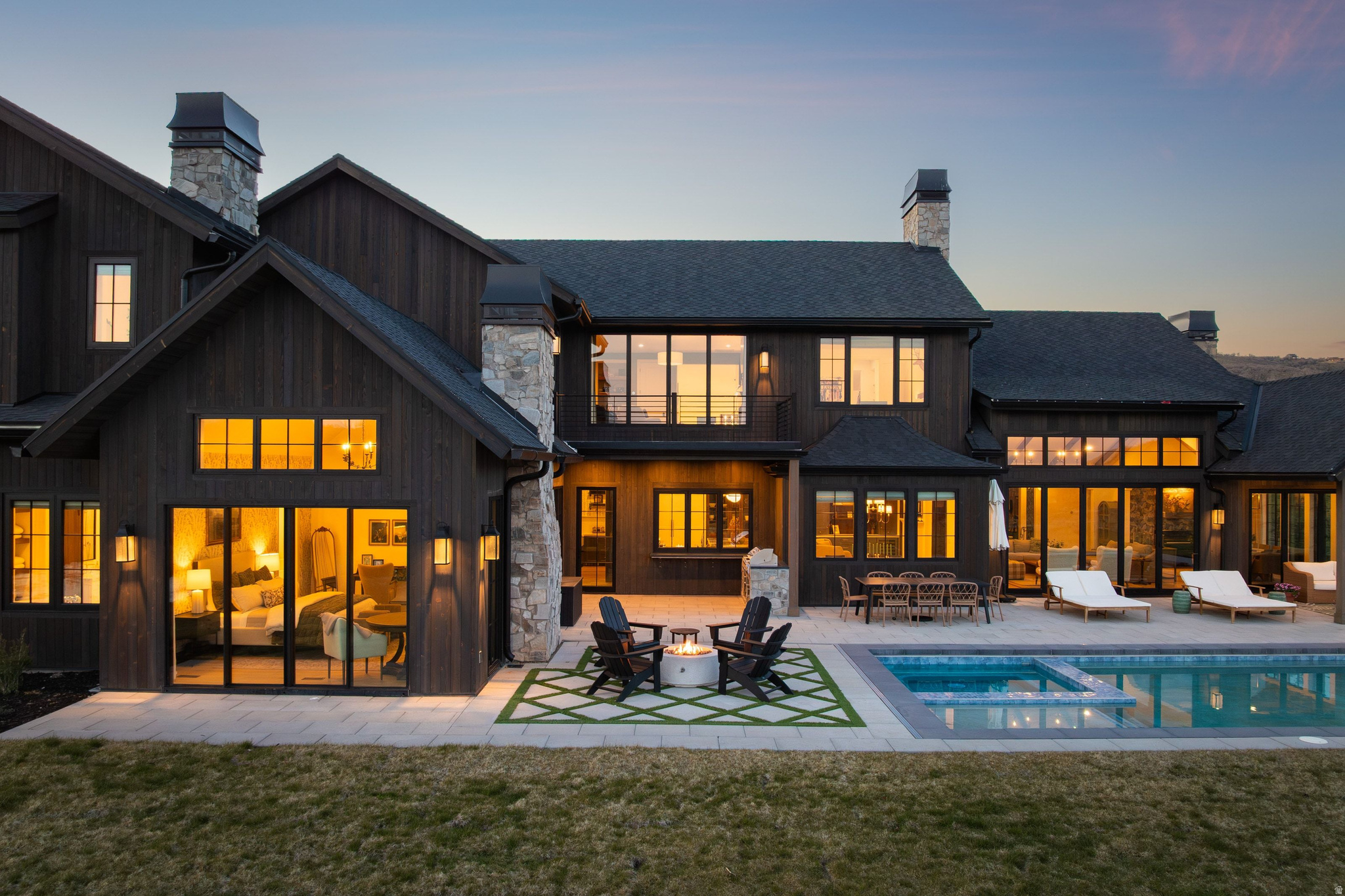 Set on 11.5 south-facing acres in The Preserve at Glenwild, this newly built Modern European Farmhouse captures sweeping Deer Valley and mountain views with refined design and seamless indoor-outdoor living. The 6,763 SF residence offers 5 bedrooms, 6 bathrooms, office, theatre room, workout room, and 4-car garage.  Vaulted ceilings with exposed wood beams and wide-plank wood flooring create a warm modern feel throughout. The chef's kitchen features a custom quartzite island, 6-burner range with griddle, paneled refrigerator and freezer, dual dishwashers, and walk-in butler's pantry. The primary bathroom features heated flooring for added comfort and luxury. Expansive living spaces open directly to outdoor entertaining areas with built-in grill, fire pit, pool, and hot tub.  The flat, usable acreage offers privacy, versatility, and future potential. One of the few properties in The Preserve with the ability to accommodate both a future guest house and horse barn. Located minutes from Glenwild Golf Club, Park City amenities, and world-class skiing.