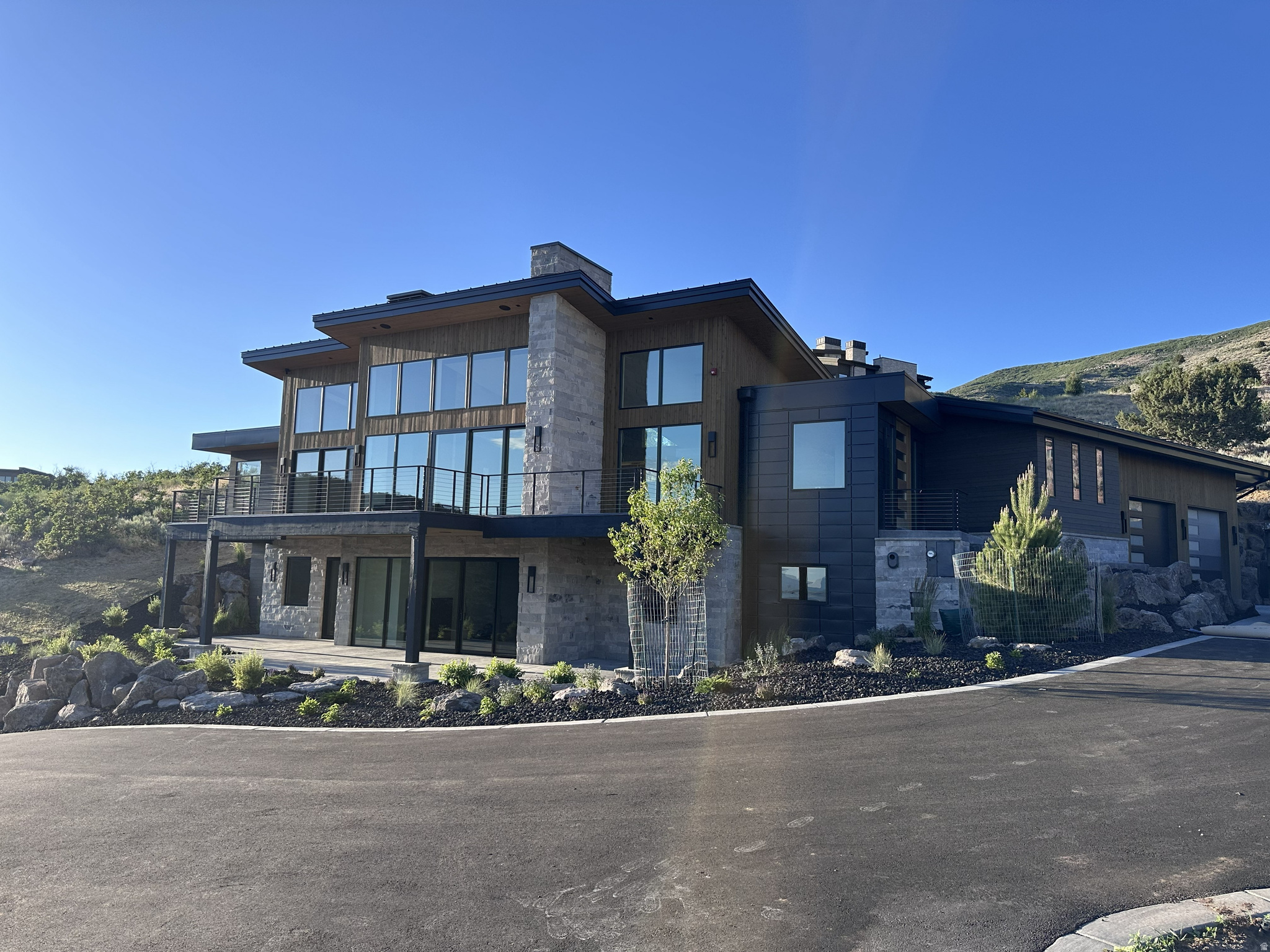 Setting the gold standard and second to none, this beautiful and luxurious home will be completed August 2026! With incredible views, a secluded, private back yard and an incredible design package this home will not only impress but will dazzle you with its beauty! The main floor features an astounding open space with a gorgeous open flame fireplace creating the perfect space for entertaining. The expansive deck flows from the interior to create a unique indoor/outdoor experience overlooking the captivating valley and mountains below. With strategic planning the home was carefully designed and placed to maximize views and avoid unwanted sun glares. The oversized master bedroom captures the incredible views with a gorgeous ensuite bathroom. With a luxurious plaster finish, a beautiful lighting package and enhanced modern earth tone details this master suite truly is a modern luxury. Additionally, the main floor features a gorgeous secluded and private back yard. Perfect for late night fire talks and games with the kids. An office or guest suite adjacent to the master completes the main level. Going downstairs you will find an additional master suite and 3 bedrooms suitable for your entire family. An added space perfect for an in-home golf simulator, theater or gym awaits your final decision. The walkout basement captures similar jaw dropping views that give a euphoric ending to any day. This paramount home, second to none is scheduled for completion in August 2026 and will be MOVE IN READY just in time to enjoy all the wonderful holidays here in the Wasatch Back. A FULL GOLF MEMBERSHIP AVAILABLE WITH PURCHASE