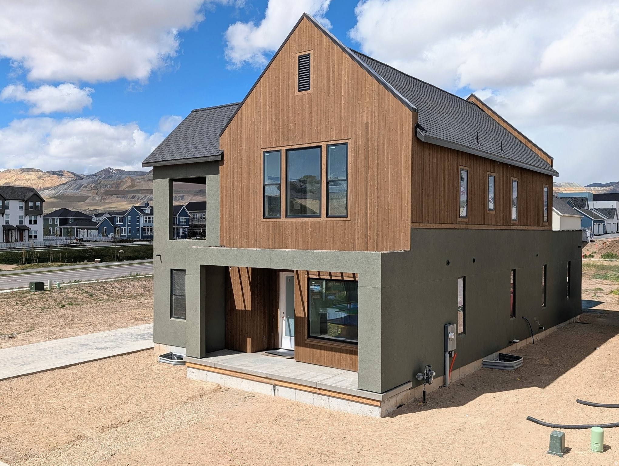 Currently under construction, this highly sought-after "Adventurer" floor plan showcases the beautiful cedar wood exterior and includes a FINISHED basement. Great livability from multiple outdoor living spaces designed to extend your living area beyond the walls of the home. The price includes impressive designer upgrades such as 9-foot ceilings on all levels, a cozy fireplace, modern railing, and a coveted indoor/outdoor layout with oversized sliding glass doors connecting the Great Room and Kitchen to the patio, perfect for entertaining. A bright main-level office is filled with natural light from abundant windows, creating an ideal space for work or relaxation. Upstairs, the dreamy Primary Suite features a private, covered balcony that is hot tubready, along with a luxurious en-suite bathroom complete with a standalone soaking tub and a spacious walk-in shower. *Interior finished photos are of a previously built home of the same floor plan for example purposes. Upgrades and finishes will vary* Estimated completion: July 2026.