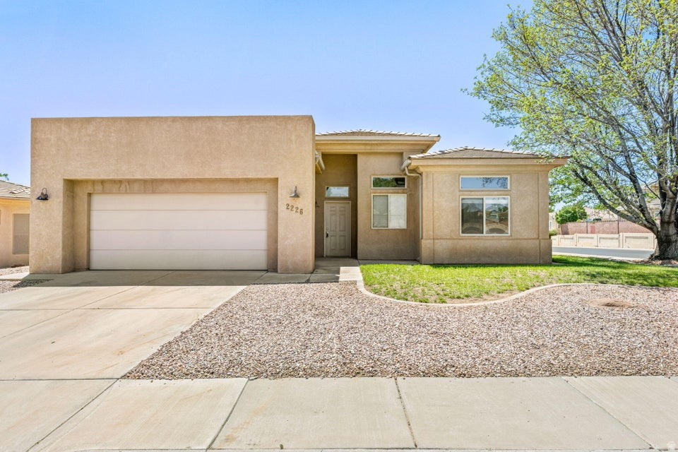 Charming 3 bedroom, 2 bathroom home with RV parking and NO HOA in Slickrock Ridge. This home offers a spacious layout with vaulted ceilings, natural light, and comfortable living spaces. The large primary suite includes an ensuite bathroom with tall ceilings and plenty of light. Enjoy the private backyard with mature trees and covered patio. Great opportunity for a first-time buyer, investment property, or anyone looking for a great property near Vasa Fitness Center, Red Cliffs Mall, Pine View Middle School, Desert Vista Park and more!