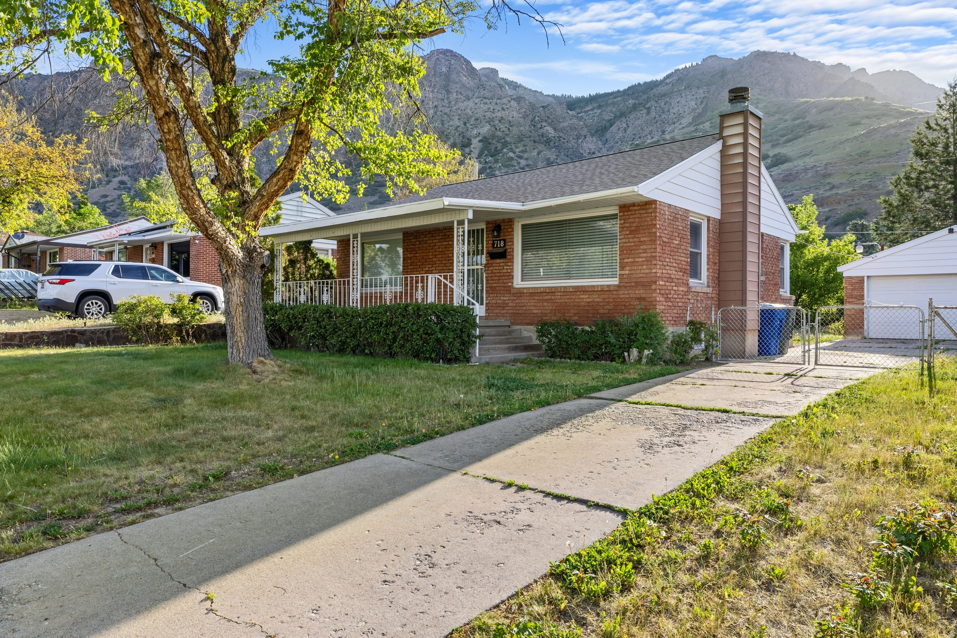 Charming brick East Side bungalow with modern updates throughout! Features a new roof, hardwood floors, and a spacious, oversized garage. Enjoy the private, flat backyard with amazing mountain views - perfect for relaxing or entertaining. The basement includes egress windows in the bedrooms for added light and safety. A great blend of classic character and modern convenience! New water softener and updated mechanical. Seller to install central air with acceptable offer.
