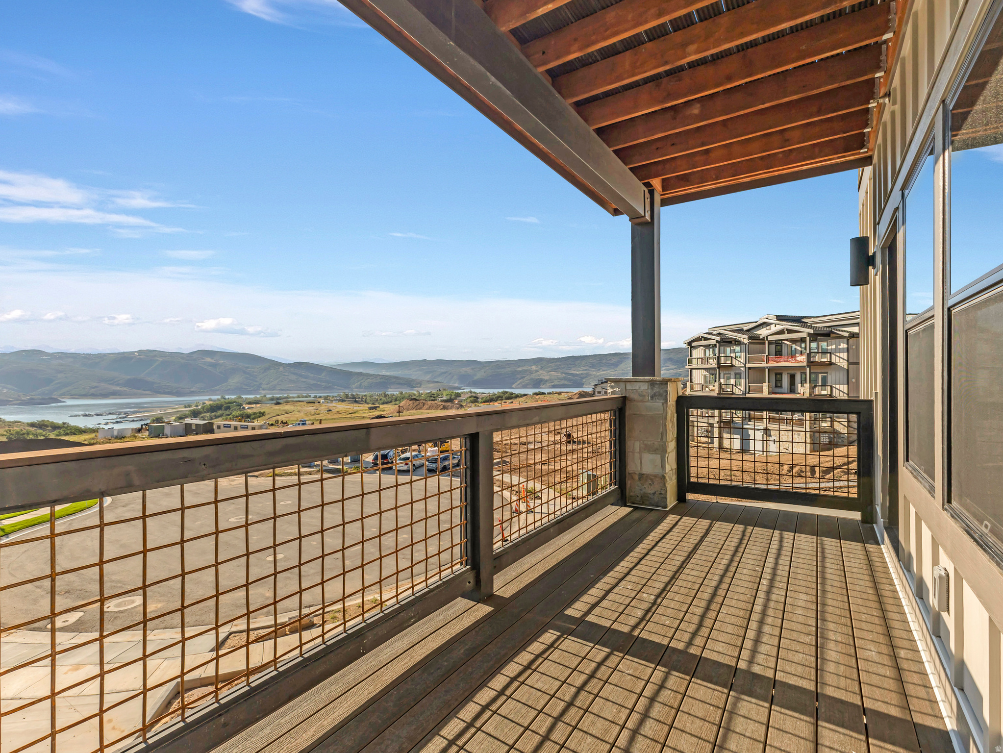 Brand new and just completed, Mayflower Lakeside Unit 204 is a corner residence with direct Jordanelle Reservoir views, positioned directly across from Deer Valley's new East Village base area. This 3-bedroom, 2-bath condo is beautifully finished throughout: custom stained oak cabinetry, granite countertops, a full suite of Viking appliances including a professional gas range, wide-plank hardwood floors, and a floor-to-ceiling stone gas fireplace anchored by a solid timber mantel. Dual-vanity baths with oversized walk-in showers carry the same custom cabinetry and stone tile finishes. A private covered balcony frames the water and marina below -- the view that defines this corner position. Ownership here is genuinely low-maintenance: keyless entry, secured underground parking with a dedicated storage unit in the garage, lock-and-leave contemporary design, remarkably low HOA dues of just $379/month, and year-round recreation at your doorstep -- Jordanelle boating, fishing and paddleboarding in summer, Deer Valley skiing in winter. Old Town Park City, Heber, and Salt Lake City International Airport are all an easy drive. With Deer Valley's East Village expansion transforming this corridor and the 2034 Winter Olympics on the horizon, Mayflower Lakeside sits at the center of one of the strongest positioning opportunities in the Park City area market -- and Unit 204's corner placement and direct water views make it the one to see.