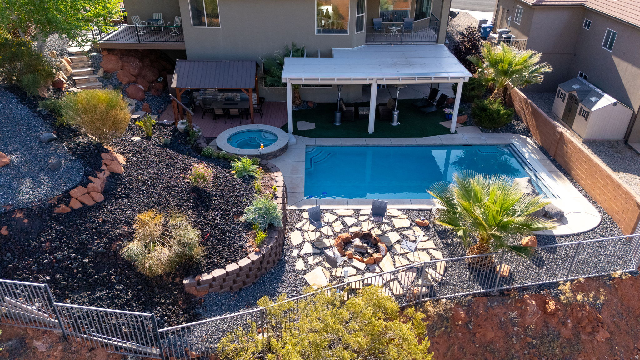 This 2017-built, 6-bedroom, 3-bath home delivers 3,767 sq ft of thoughtfully finished living space across two full levels. The main floor centers on an open layout with a well-appointed kitchen featuring granite countertops and all appliances included, flowing into a dining area and out to a covered deck. The primary suite is a true retreat with a separate tub and shower, walk-in closet, and its own private deck - a perfect perch for taking in the mountain views. The fully finished walk-out basement adds serious flexibility with a second family room (projector stays), three additional bedrooms, a full bath, and huge dedicated storage room. A 3-car attached garage with water softener round out the practical features. Out back, the fully fenced yard is built for entertaining -- gunite pool and in-ground hot tub with separate heaters, outdoor kitchen, covered and uncovered decks, and low-maintenance turf and xeriscape. Situated in Middleton with open space on three sides. Convenient location with easy access to shopping, trails and freeway. No HOA. Agents please see private remarks.
