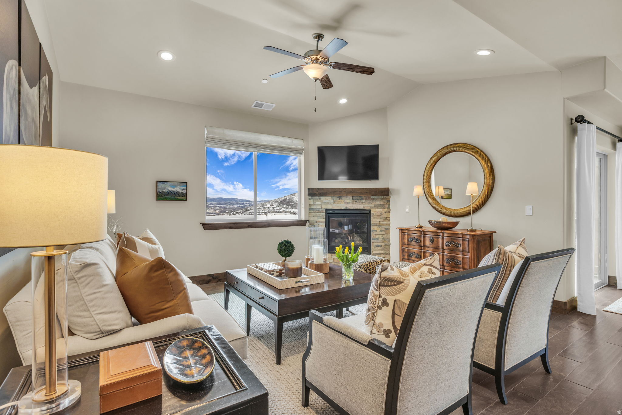 This top-floor, corner residence in Black Rock Ridge offers added privacy, vaulted ceilings, and expansive views toward Deer Valley and the Wasatch Mountains, all while being set back from the highway. Oversized windows fill the open-concept living space with natural light, anchored by a stone fireplace and hardwood floors. The kitchen features granite countertops, stainless steel appliances, rich wood cabinetry, and bar seating, flowing seamlessly into the main living and dining areas. The home has been professionally furnished by Barclay Butera (sold unfurnished), showcasing a warm mountain-modern aesthetic. The primary suite is complemented by two additional bedrooms and a second full bath, along with a dedicated laundry room and a private detached single-car garage. Seven-night minimum rentals are allowed, pets are permitted, and trails are just outside the door. Enjoy proximity to Black Rock Hotel amenities, Deer Valley, Park City Mountain, Jordanelle Reservoir, and Historic Main Street.