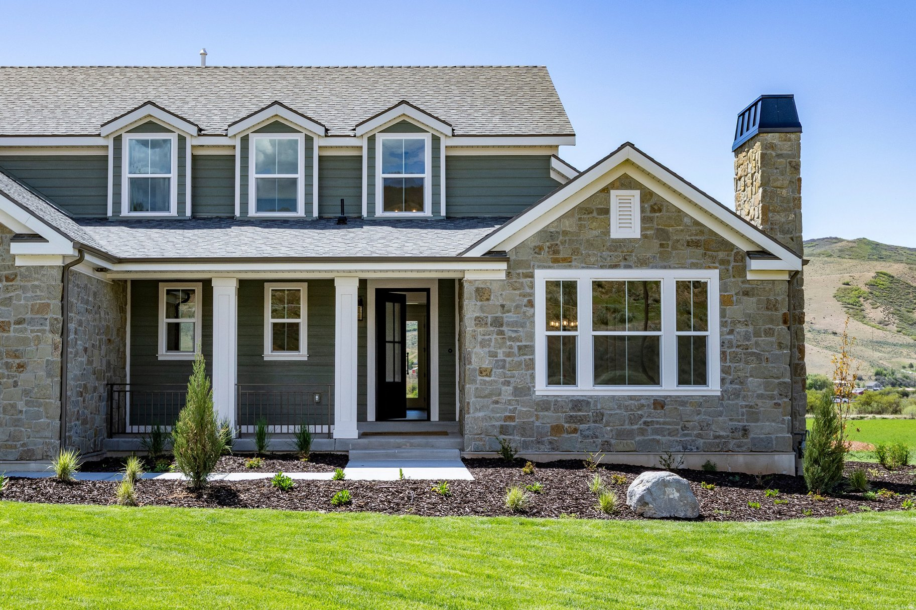 Brand-new construction tucked into Countryside Estates - an intimate 12-homesite community in Coalville, just 10 minutes to Park City - the Hampton blends refined living with wide-open space, surrounded by 31 acres and offering inspiring views with horse property potential. A covered porch opens to a bright entry, dramatic staircase, and elegant formal living and dining rooms with coffered ceilings, plant shelves, and recessed lighting. The stunning two-story family room features an optional fireplace framed by five large windows. The gourmet kitchen boasts a large island and corner pantry, and even the laundry room offers ample cabinetry and counter space. The main-floor owner's suite includes double sinks, a garden tub, separate shower, and walk-in closet. Upstairs bedrooms feature generous closets and share a spacious hall bath. New construction, luxury, comfort, and Park City recreation - all in one exceptional home.
