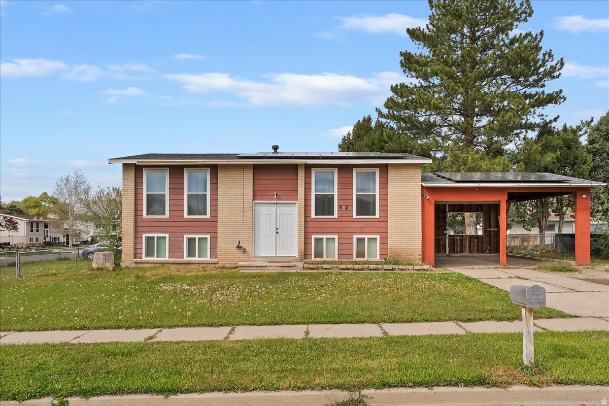 ** CORNER LOT, FULLY FENCED, ON QUIET STREET ** Large family room perfect for entertaining. Extra cabinets in the kitchen and dining area. 2 large bedrooms and 1 bathroom upstairs. Basement fully finished with a family room, a den area, 2 bedrooms, and 1/2 bath. Laundry in the basement. Also has a walkout basement to the backyard. Just off the kitchen, there are French doors leading to a large deck. Mature trees and a large yard. Fully fenced backyard. The 2-car carport is easy to enclose to make it an oversized garage. Also has plenty of RV parking. Solar panels installed in 2021 and are fully paid off.  All windows and the front door were fully replaced in 2023. Square footage figures are provided as a courtesy estimate only and were obtained from a previous MLS listing. Buyer is advised to obtain an independent measurement. Agent is related to the seller.  Property Website: https://view.reelmediautah.com/954-W-2400-N