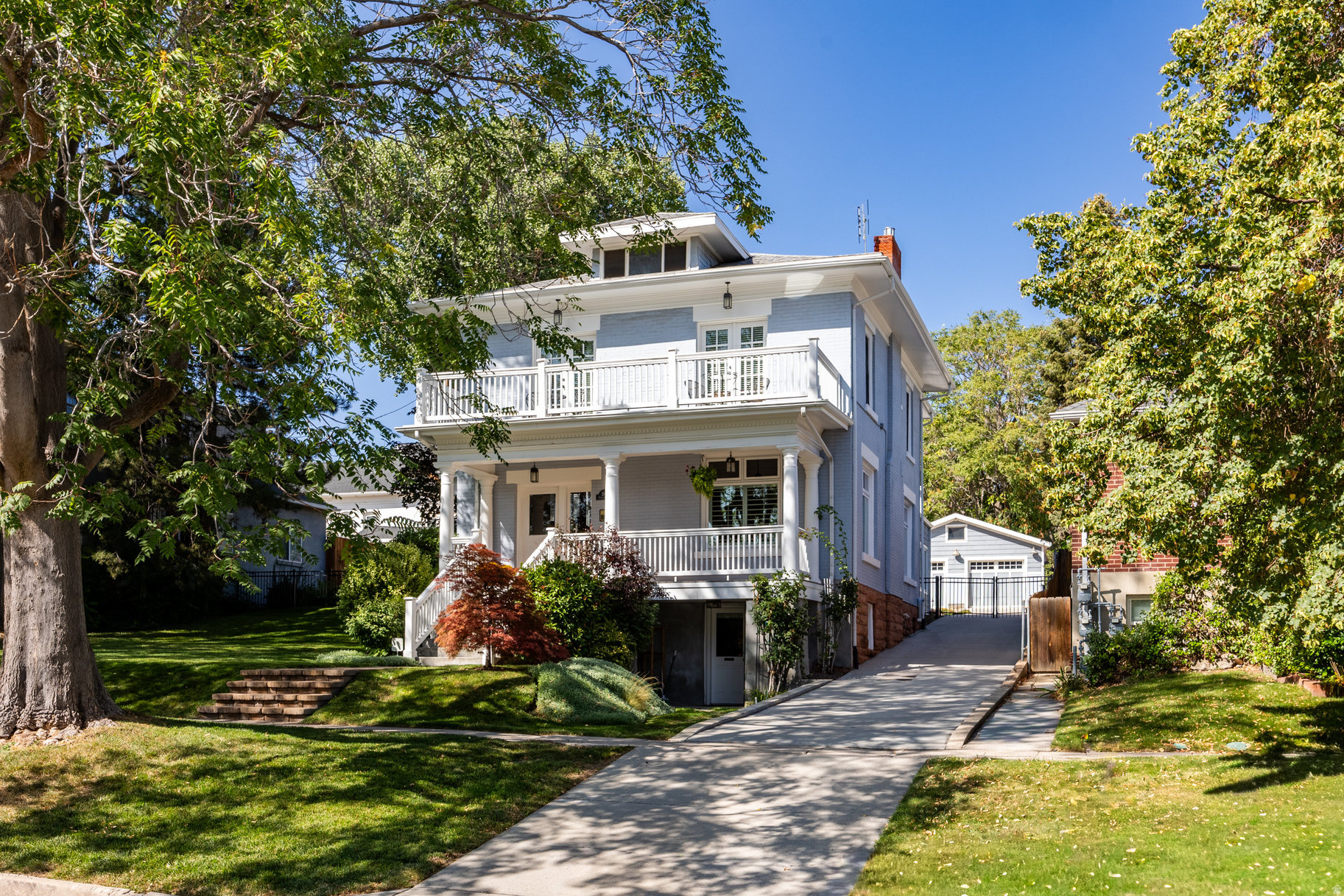 An iconic Avenues residence, this stately 2-story Four Square blends timeless architecture with modern sophistication. A stunning entryway with a graceful double staircase opens to elegant formal living and dining spaces, rich Brazilian cherry flooring, and a beautifully updated kitchen that flows seamlessly into an expansive great room addition complete with heated floors-perfect for gathering and entertaining. The oversized primary suite is a true retreat, featuring a spacious walk-in closet, a luxurious bath, and direct access to the back balcony overlooking the lush backyard. A fabulous sitting porch, paired with a front balcony -extend the living spaces outdoors. Rare for The Avenues neighborhood, the .30-acre lot offers garden space, a beautiful paved patio, an oversized two-car insulated garage, RV parking, and ample room to design your dream outdoor retreat. The lower-level apartment offers flexible living-ideal as a rental or easily reincorporated into the main home. All within steps of downtown, City Creek Canyon, Memory Grove, shopping, dining, and the vibrant Avenues lifestyle. This house might just have it all.
