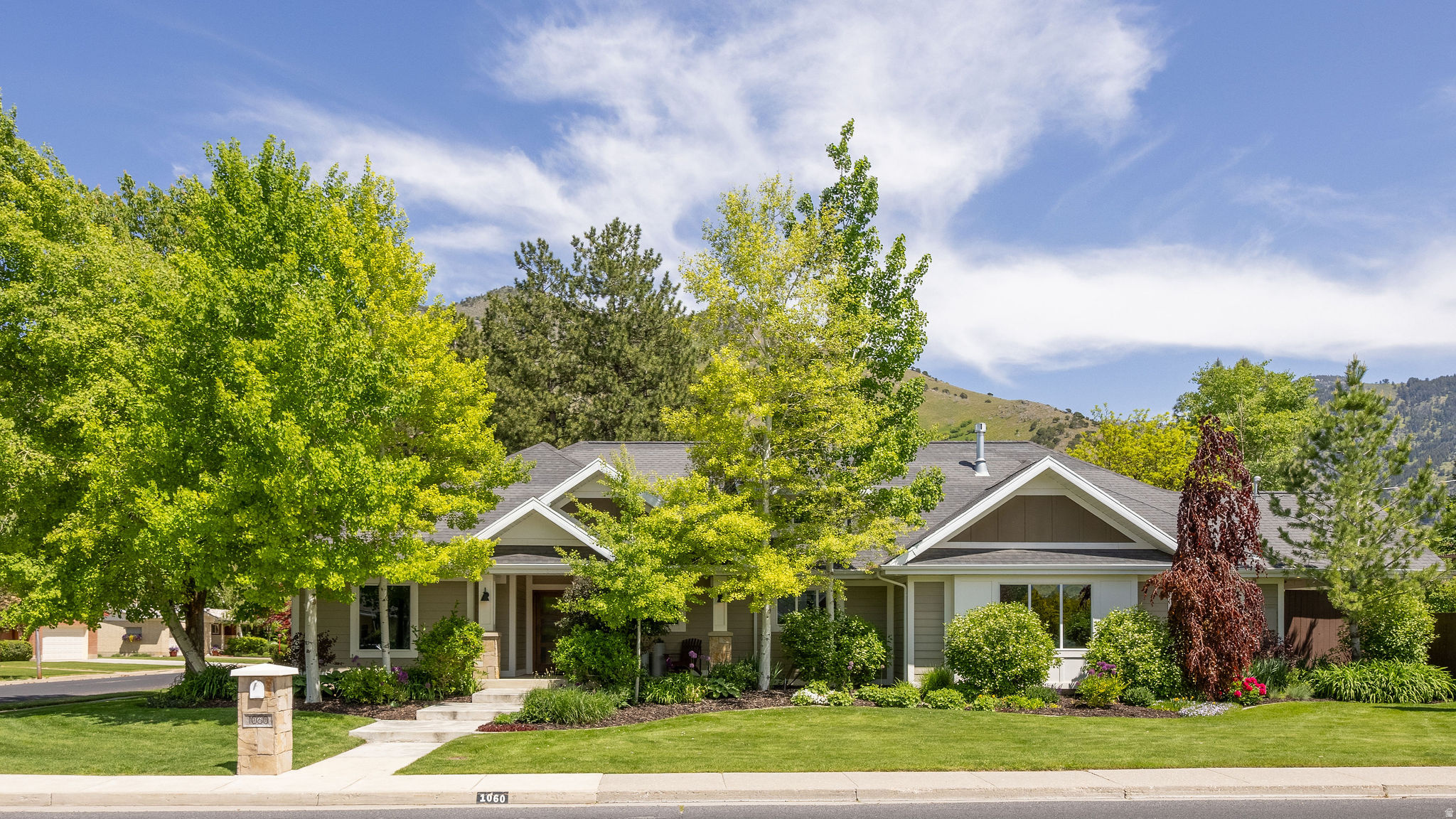 BEAUTIFUL UPDATED SINGLE-LEVEL HOME IN PRIME LOCATION! This beautiful home is located above USU, between Lundstrom Park and Logan Country Club, and only a few blocks from the Bonneville Shoreline Trail in Cache Valley's most-desirable east-bench neighborhood. This fully-updated home is all on one level with four bedrooms, a separate office with expansive views of the Wellsville Mountains and the secluded backyard, multiple family/sitting rooms, plus a huge Master Bedroom with a private sitting area, separate jetted tub/shower, and dual vanities. You'll love the oversized gas fireplace in the large living room with vaulted ceilings, plus the kitchen comes complete with dual ovens and gas range and quarter-sawn walnut cabinets with white quartz countertops. The yard is fully landscaped with a large covered deck, patio with a dining area, pergola with a gas firepit, raised vegetable garden, mature trees, and more. The garage is fully finished, insulated and heated, has a roll-up door to the backyard, and a 220V outlet for an electric car charger or anything else that requires additional power. The side-entry driveway gives you plenty of room to park and an easy entry to and from the home, plus there is additional parking next to the driveway and behind the double gate in the fully-fenced backyard. There is additional storage in the basement as well. Agent/Owner