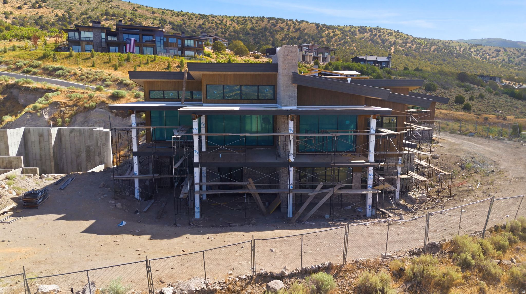 This jaw-dropping Mountain Masterpiece is ready to join the most prestigious luxury homes in Red Ledges premiere golf community. Elevated high on the hillside of A1 Peak Dr, this extraordinary custom-built estate embodies the very best of luxury mountain living. The home enjoys an unrivaled position overlooking sweeping, panoramic vistas of the dramatic peaks of Mount Timpanogos and the vast Heber Valley below. From sunrise to sunset, the views are nothing short of cinematic, with ever-changing light and color spilling across the mountains. Designed with the utmost attention to detail and craftsmanship, the residence blends modern sophistication with timeless mountain architecture, offering a lifestyle of elegance, comfort, and effortless indoor-outdoor living. The home's striking entry gives way to soaring ceilings, open living spaces, and walls of floor-to-ceiling glass that seamlessly bring the outdoors in, framing the iconic mountain scenery from nearly every room. A Main-level primary suite serves as a private retreat, thoughtfully designed with glass walls that open to the views, a luxury spa bathroom, and direct access to the large walk-out viewing deck. The home offers a total of five bedrooms, each generously proportioned, and multiple grand living rooms that provide both intimate spaces for quiet evenings and expansive areas perfect for entertaining guests. Car enthusiasts will find a rare opportunity with a five-car garage, offering not only space for a collection of vehicles, but also the perfect environment for storage, hobbies, or a private showroom. Beyond the finished living spaces, the home includes 1200 square feet of unfinished space on the lower level, an exciting blank canvas awaiting the vision of its new owner. Whether transformed into a state-of-the-art golf simulator, a luxurious home theater, a professional-grade gym, or even a private spa and wellness retreat, the possibilities are endless.
