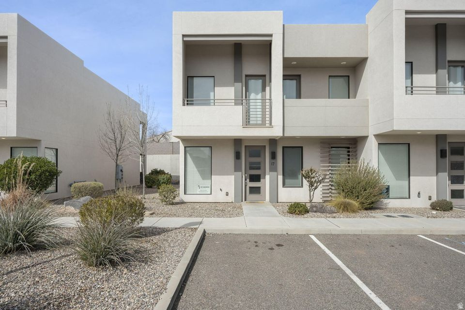 Welcome to Lofts at Green Valley, a fully furnished, turn-key vacation rental offering style, comfort, and exceptional investment potential. This modern 4-bedroom, 3.5-bath retreat is designed to accommodate large groups with ease. The open-concept main level features a sleek kitchen with quartz countertops, stainless steel appliances, generous cabinetry, and bar seating that flows seamlessly into the spacious living and dining areas. Contemporary finishes, clean lines, and abundant natural light create a bright and inviting atmosphere throughout. Upstairs, thoughtfully designed sleeping spaces provide flexibility, including bunk rooms ideal for maximizing occupancy. The primary suite offers a private balcony, walk-in closet, and well-appointed ensuite bath. Additional bedrooms and bathrooms are tastefully finished to comfortably host. Enjoy your private covered patio for outdoor enjoyment, plus convenient in-unit laundry and ample storage. The Lofts at Green Valley community offers outstanding HOA amenities including a resort-style pool, hot tub, playground, and pickleball courts, all just minutes from golf courses, hiking and biking trails, Snow Canyon, Tuacahn Amphitheatre, and all that St. George has to offer.