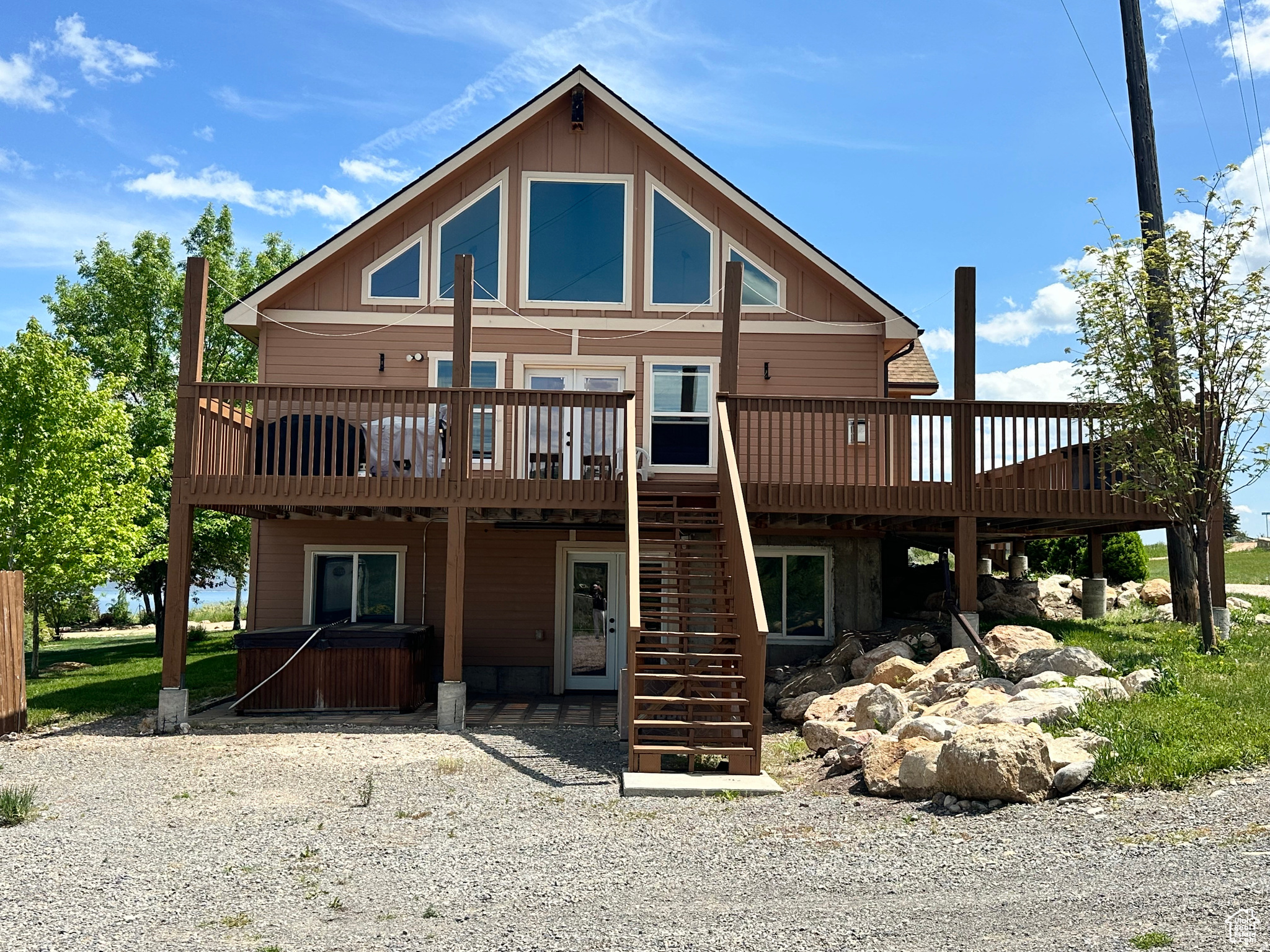 This thoughtfully designed mountain retreat offers comfort, efficiency and exceptional functionality for large groups and year round enjoyment. The exterior has recently been stained, and the home features a new tankless water heater that provides abundant hot water for multiple showers simultaneously. Built with quality 2x6 construction and additional insulation in the walls and floors, the cabin is energy efficient, quiet, and incredibly well insulated for all seasons. Located at the end of the subdivision on Fremont street, this property enjoys minimal traffic and a peaceful setting. Easy year round access makes it ideal for both full time enjoyment and vacation use. The spacious layout was carefully designed for gathering large families and groups, with expansive kitchen and great room areas perfect for entertaining. The flexible bathroom layout allows for private lockout style suites or convenient hallway access for guest. Outdoor recreation is right at your fingertips with nearby golf access, ATV trails, and 4-wheeling opportunities. Owners also enjoy access to Bear Lake West amenities including pool, pickleball courts, tennis courts, hot tub, private beach access, and golf privileges. **Optional Fractional share available- Call Agent for details.