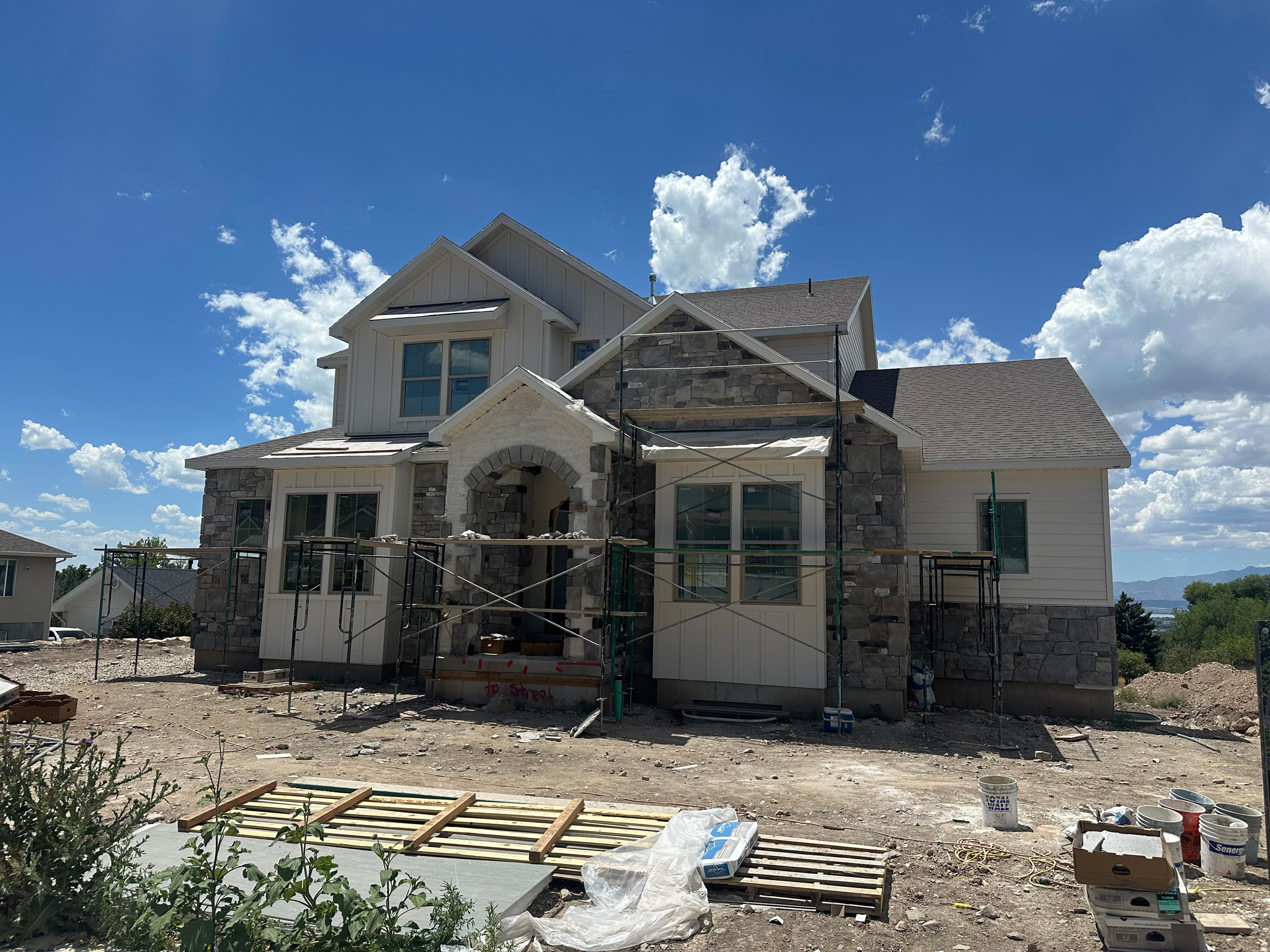New construction home in Pleasant Grove at the base of Mount Timpanogos, this 7-bedroom, 4.5-bath home offers a spacious, functional layout with high-end finishes throughout. The main level features 10' ceilings, a private primary suite with a custom tile shower and freestanding tub, plus convenient main-floor laundry. The kitchen includes custom cabinetry, quartz countertops, Caf appliances, and a Frigidaire refrigerator/freezer. Upstairs, you'll find three bedrooms, two full bathrooms, and a large laundry room. The finished walkout basement adds three more bedrooms, a full bath, kitchenette, pantry, and plenty of space for guests, entertaining, or multi-generational living. Estimated completion is early September. A beautiful new home in a great Pleasant Grove location.