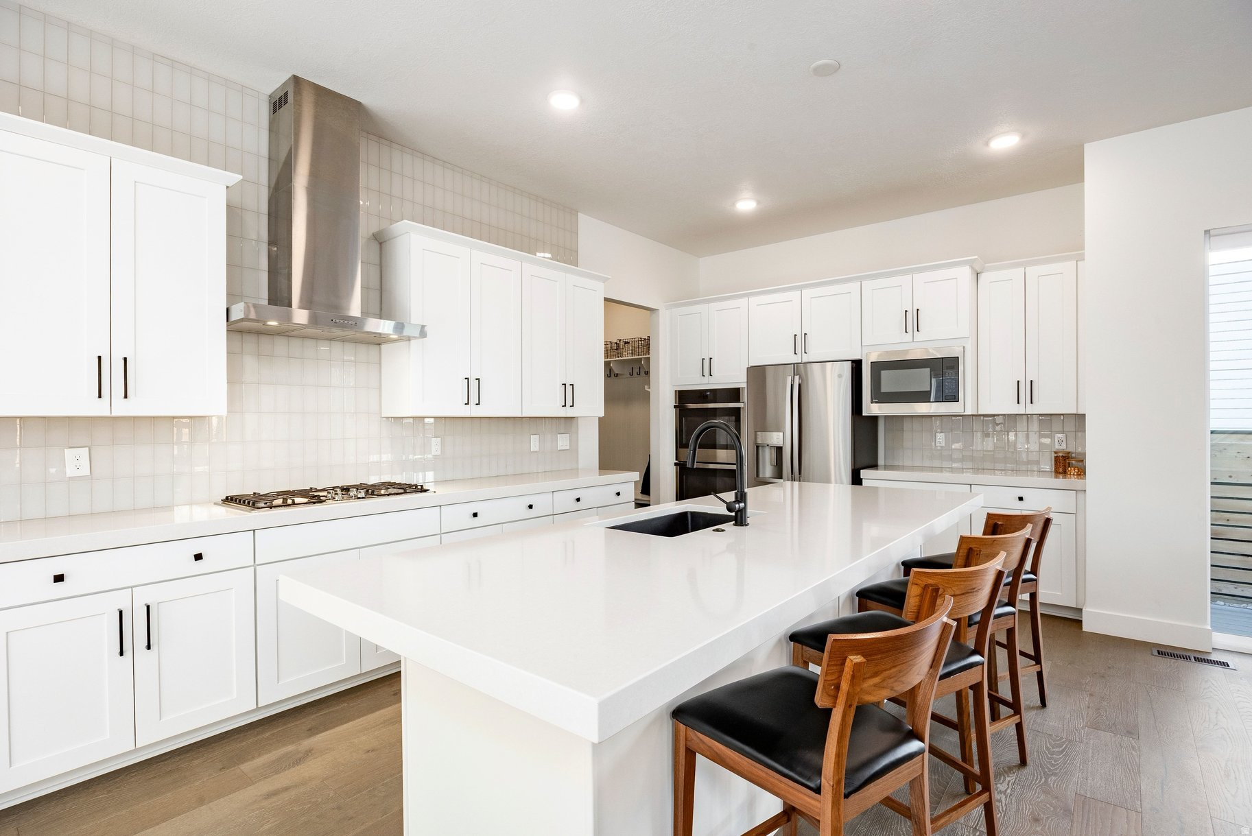 Impeccably crafted and fully furnished residence in Silver Creek Village, one of Park City's newer lifestyle-rich communities, offering a thoughtful blend of style, space, and versatility. The open main level is centered around a chef-inspired kitchen with a large island, quartz countertops, double ovens, a gas cooktop with direct venting, and a generous workspace, all seamlessly connected to the dining and living areas. The well-designed floor plan offers three separate living areas, including a main-level great room, upper-level loft, and lower-level family room, creating room for gathering, privacy, guests, work-from-home needs, or relaxed mountain living. Soaring 10-foot ceilings on the main level and 9-foot ceilings upstairs enhance the home's open, airy feel. Enjoy a covered deck and fully fenced yard, ideal for entertaining, pets, or quiet evenings outdoors. With an oversized two-car garage, extra driveway parking, included furnishings, and easy access to Park City's recreation, dining, trails, skiing, and everyday amenities, this move-in-ready home is designed for effortless mountain living from day one.