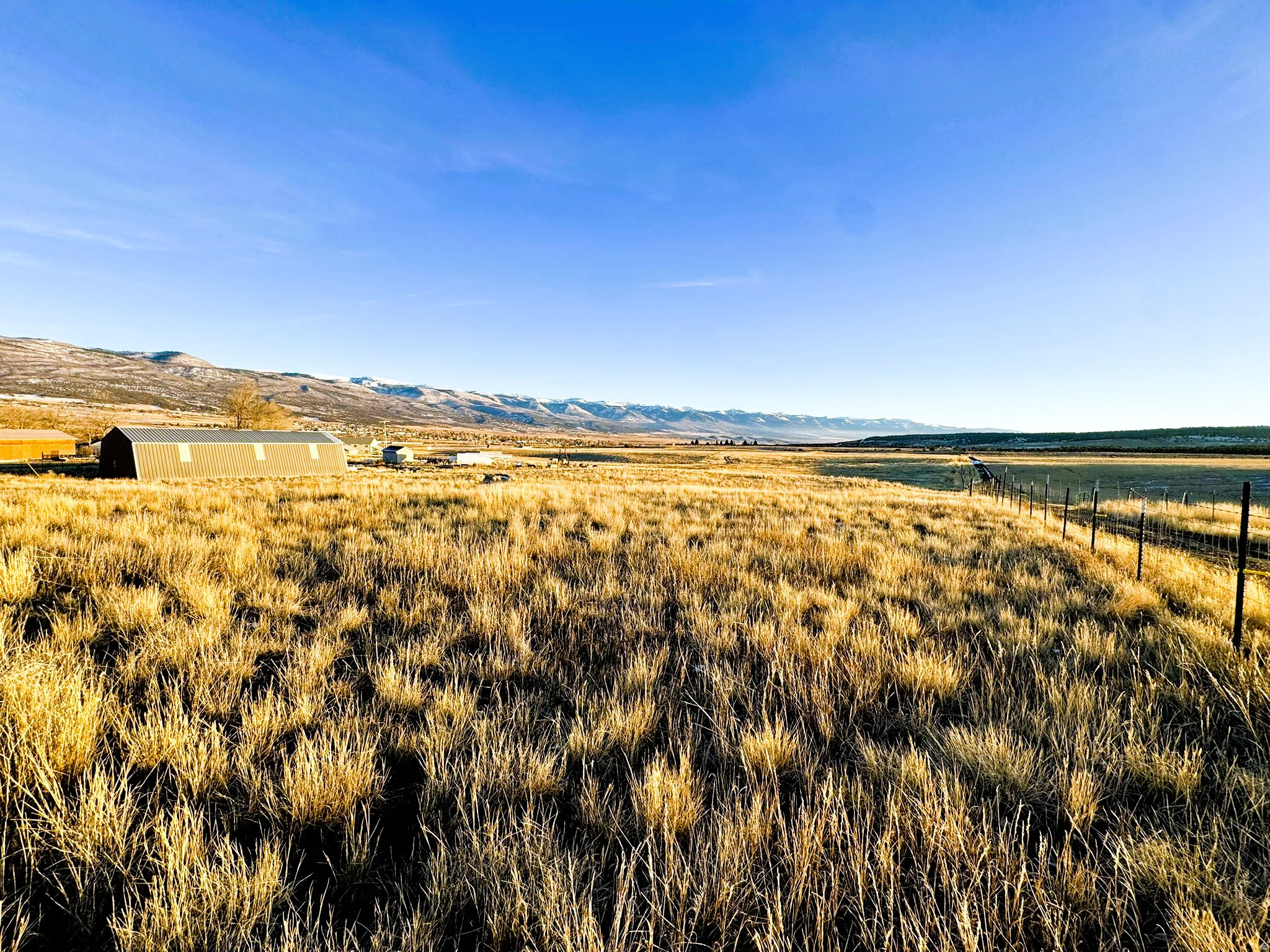 3.34 acres with power, culinary city water, a large shop, and water shares-just 45 minutes to Spanish Fork. Enjoy sweeping, unobstructed views of the Fairview and Mt. Pleasant valleys on this exceptional property offering usable acreage, existing infrastructure, and future flexibility, with zoning that allows minimum one-acre parcels (buyer to verify). A 36' x 72' metal shop/barn is already in place with power, culinary city water, and a concrete floor, providing a rare head start for a homesite, hobby farm, or recreational basecamp. Three Class II water shares with Devil's Pass Water Company are included.  Located on a county-maintained road, with close proximity to the Manti-La Sal National Forest and easy access to the Skyline Drive ATV trail system. Miscellaneous equipment is not included. Buyer to verify all information.
