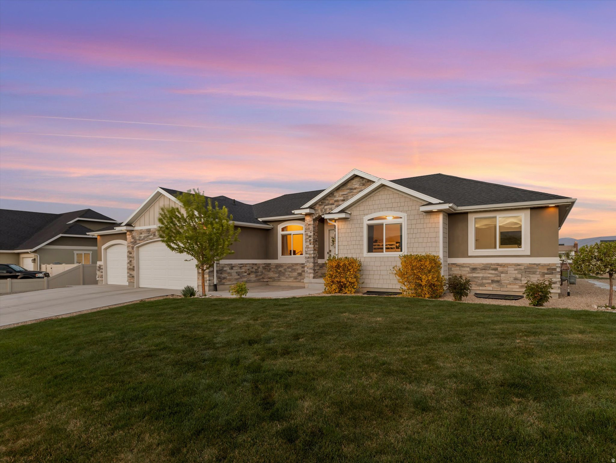 If you've been waiting for space... this is it.  Set on a full half acre in Grantsville, this 5-bedroom home gives you something that's getting harder to find, room to breathe, room to gather, and room to live the way you want.  Inside, the home opens up with vaulted ceilings, warm natural light, and an easy, open flow that just feels right. The kitchen is the heart of it all, with granite countertops, a large island, and plenty of space for everything from weeknight dinners to weekend hosting.  The main-level living area is both comfortable and elevated, featuring a statement fireplace and large picture windows that connect you to the backyard. Downstairs, the fully finished basement gives you flexibility movie nights, game space, or separate living for guests.  But the real story is outside.  A massive, fully fenced yard with a gazebo, fire pit, and play area creates your own private backyard retreat. There's space for RV parking, trailers, and toys. This is the kind of property where you can actually use your land, not just look at it.  Quiet gated neighborhood. Mountain views. Freedom to live how you want.  Homes like this don't come around often.