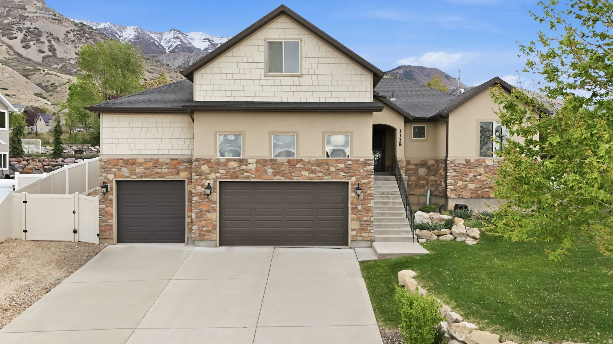 Stunning mountain and lake views + unbeatable location! Just one street from the scenic Murdock Canal Trail. This beautifully maintained home offers the perfect blend of comfort, functionality, and outdoor living. Inside, you'll appreciate thoughtful updates throughout, including new LVP flooring in the kitchen and several major systems upgrades completed in recent years, giving you peace of mind and move-in ready convenience. The oversized garage is a standout featuring an extra deep third bay, a lofted workshop space or storage area, 220 outlet, and attic access perfect for hobbies, gear, or future projects. With two separate entrances, from the garage into the home, there's incredible potential to convert the basement into an ADU or mother-in-law apartment. The basement includes two completed bedrooms, with additional framing and electrical in place, plus a shower pan ready for your finishing touches. Step outside and fall in love with the backyard oasis, complete with a vegetable garden & raised strawberry garden box, mature fruit trees (honey crisp apple, Canadian Harmony peach, and sweet cherry), and a cozy fire pit for relaxing evenings.  The landscaping has been thoughtfully curated with beautiful details like a yellow magnolia tree, rose of Sharon, deep purple clematis, and a white climbing rose draped over the arbor. Enjoy breathtaking lake & valley views from the front and peaceful mountain views from the backyard. This is the kind of setting that never gets old. Open house Saturday, April 18th, 11 AM to 1 PM.