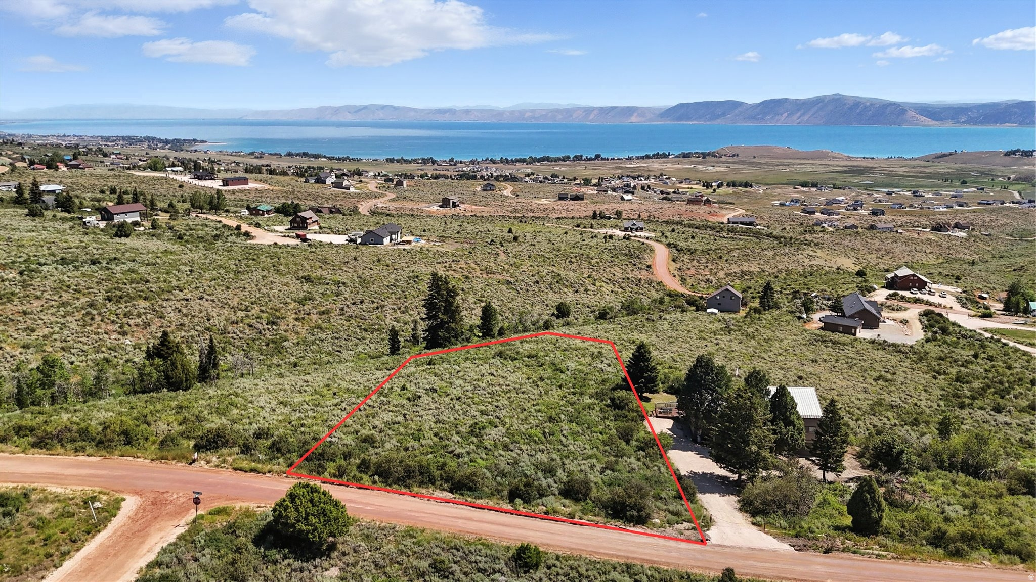 Build your dream cabin on this 1.35-acre lot with stunning Bear Lake and Wasatch Mountain views. Located in the Sweetwater Subdivision, this gently sloped parcel offers year-round access, nearby utilities, and the rare bonus of an active bald eagle nest nearby. Optional Ideal Beach Resort Membership includes private beach, pools, hot tubs, and more. Close to Garden City, Beaver Mountain, marinas, and trail systems  perfect for year-round adventure. Buyer to verify all info.