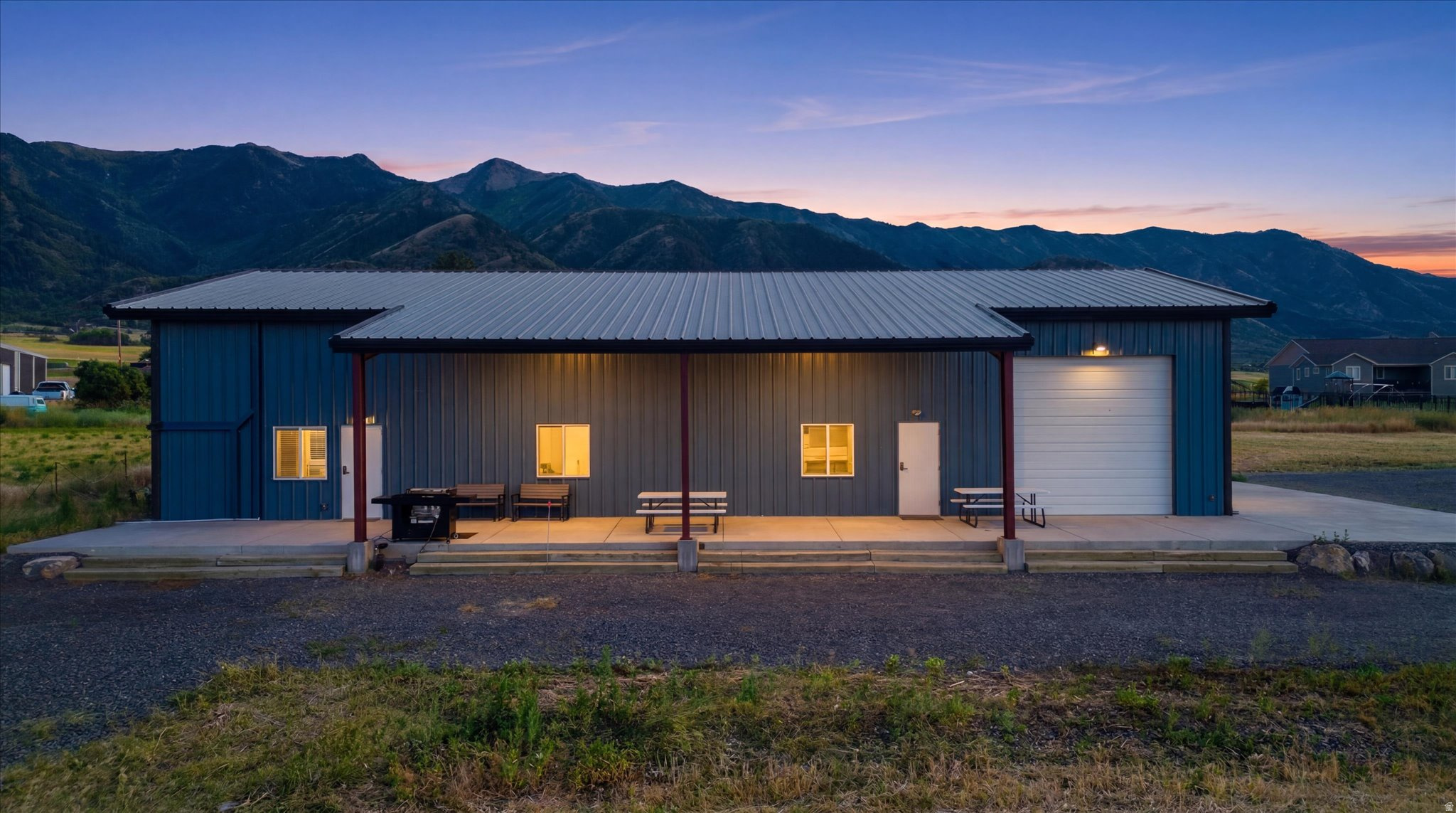 Experience the best of country living with this exceptional Barndominium situated on 12.910 acres in scenic Wellsville, Utah. Surrounded by breathtaking, unobstructed views of the Wellsville Mountains and Cache Valley in every direction, this rare property offers privacy, functionality, and endless possibilities. Designed with quality and comfort in mind, this 2 bedroom, 3 bathroom home features upscale finishes throughout, spray foam insulation in the living space and garage for outstanding energy efficiency, and individual heating and cooling units in every bedroom and living area, each with its own thermostat and controller. Smaller room with bunk bed is great for kids and guests and the spacious upstairs family room includes a wet bar with a sink, cabinetry, and a mini refrigerator, creating the perfect space for entertaining. One large lower-level bedrooms featuring a private entrance, offering flexibility for guests, a home office, or multi-generational living.  One of the property's most valuable features is its future potential. The septic system is sized to accommodate an additional custom home and already includes a stubbed drain line, allowing you to comfortably live in the Barndominium while building your dream residence. The approximately 2,000 square foot garage is built to impress. Equipped with two insulated automatic roll up doors, two natural gas ceiling heaters, two 220 volt receptacles on each side, and abundant electrical outlets throughout, the space is ideal for hobbies, equipment, or recreational use. It is currently set up with a pickleball court, basketball hoop, and two ping pong tables, making it a truly versatile extension of the home.    The property is equally impressive outside. The private well produces approximately 1,000 gallons per minute and is housed in a matching outbuilding with 16 electrical panels designed to support future equipment and expansion. The land is fully fenced for livestock and thoughtfully designed for those seeking a productive agricultural lifestyle. With the majority of the acreage dedicated to a meticulously maintained hay field, this property offers exceptional agricultural value. The land serves a dual purpose by generating seasonal income through high-quality hay production while also providing quality feed for livestock. Whether your goal is to operate a hobby farm, expand an agricultural operation, or help offset ownership costs through farming revenue, this property is ready to support your vision.    Located in the heart of Cache Valley, you'll enjoy convenient access to outdoor recreation including hiking and mountain biking in the Wellsville Mountains, fishing and boating at nearby reservoirs, ATV and horseback riding trails, world class skiing at Beaver Mountain, and countless opportunities to explore Northern Utah's scenic landscapes. Despite its peaceful rural setting, the property is just minutes from Wellsville, Logan, shopping, dining, and Utah State University, offering the perfect balance of country living and everyday convenience.  All appliances are included in the sale, and all furnishings are negotiable with sale as well.     Properties offering this combination of modern construction, income producing land, future building potential, and unforgettable views that rarely become available.    Square footage figures are provided as a courtesy estimate only and were obtained from the Seller and County records. Buyer is advised to obtain an independent measurement.