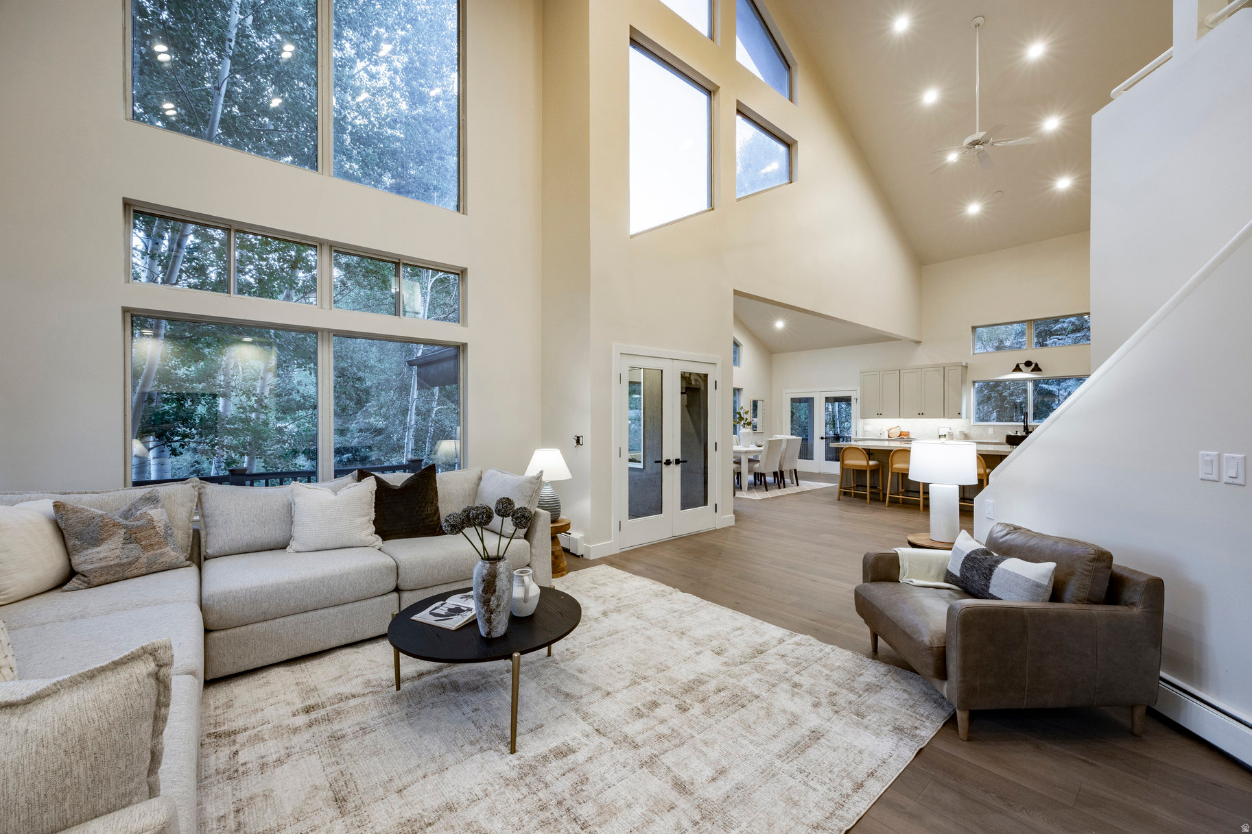 Tucked in the towering pines and aspens of Hidden Cove in Jeremy Ranch, this beautifully remodeled mountain retreat blends timeless design, modern amenities, and an unbeatable location. As autumn colors emerge and winter's first snow dusts the trees, this home becomes a front-row seat to Utah's most breathtaking seasons.Set on over half an acre, the property offers rare privacy while maintaining effortless proximity to world-class skiing, scenic trails, Park City's Main Street, and downtown Salt Lake City. The home's clean, sophisticated aesthetic features sun-drenched open living spaces, custom cabinetry, and high-end finishes throughout. The great room is a showpiece with vaulted ceilings, expansive windows, and a stunning fireplace-perfect for cozy evenings or watching snow fall through the aspens. The designer kitchen is ideal for entertaining, with a large prep island, double ovens, heated floors, and covered decks that invite outdoor dining even in cooler months. The main-level primary suite offers a luxurious retreat with a fireplace, large walk-in closet, and spa-like bath with soaking tub and dual vanities. Additional highlights include a home office with private walkout (or optional fifth bedroom), generous laundry room, walk-in pantry, and flexible loft spaces for reading, work, or play. Outside, mature trees and stone pathways create a private, woodland setting, alive with fall color and winter stillness. Triple-pane windows, a boiler heating system, and newer mechanicals ensure long-term comfort and efficiency, while the four-car tandem garage accommodates every season's gear. Frequent sightings of elk, moose, and deer add to the home's mountain charm. This is a rare opportunity to own a refined retreat where natural beauty, thoughtful design, and four-season living converge.