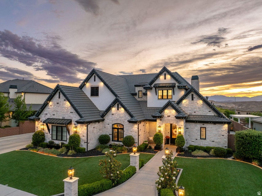 This is not a home, it's an experience. This fully customized Little Valley estate delivers over $800K in upgrades and a rarely seen level of detail. From the moment you walk in, the scale, design, and finishes set the tone. Soaring ceilings, statement fixtures, and perfectly curated ambient lighting are all controlled by a full Control4 smart home system. The kitchen is built for gathering, featuring an oversized island, butler's pantry, high-end appliances, custom cabinetry, and seamless flow into expansive living spaces. The primary suite features vaulted ceilings with exposed black beams creating a striking contrast with the recessed lighting and a chandelier. The spa-inspired bathroom showcases a double vanity with pendant lighting, a freestanding bathtub, and glass doors isolating the large walk-in shower. The spacious walk-in closet offers an organized layout with a central island, multiple drawers, and double-tier hanging rods. On the main level you can focus on the designated office or work out in the fully equipped home gym with perfect lighting. Upstairs, the fully immersed movie theatre creates a true cinematic experience, including an additional living room and hang out den. Step outside and everything changes. The backyard is a private resort complete with a custom pool, hot tub, waterfall, and rockslide. The outdoor living space built with a modern design, stone pillars, built in counters and accent lighting is next level. It features a fully built-out kitchen with a pizza oven, BBQ, fireplace, integrated heaters, and a TV. Designed for year-round use, put the shades down, turn the fireplace on and enjoy a cozy winter evening. The private sports court is accompanied by high-end artificial turf. Whole-home audio with surround sound carries throughout the interior and exterior of the property, creating a seamless indoor-outdoor experience. No HOA. No compromises. No comparison. This is one of those properties that simply doesn't come around often