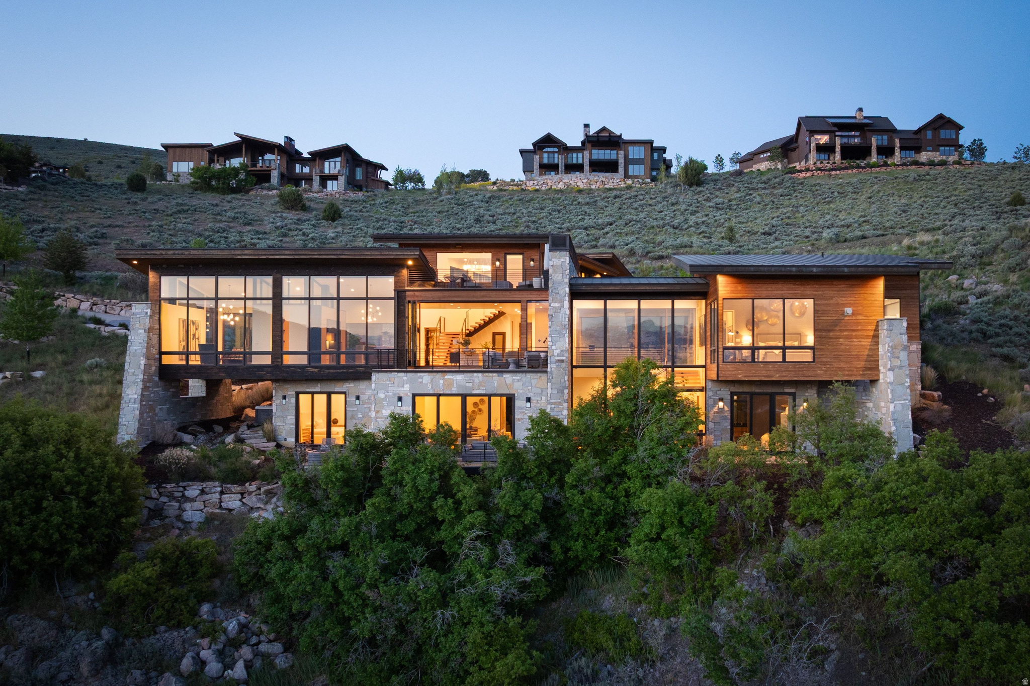 Perched along one of Red Ledges' premier ridgelines, this exceptional mountain contemporary home by Pure Haven Homes captures sweeping panoramic views of the Heber Valley and Mount Timpanogos. Thoughtfully designed with soaring ceilings, dramatic walls of glass, and refined architectural details throughout, the home seamlessly blends luxury, comfort, and functionality.  The open-concept floor plan is centered around a chef's kitchen featuring a full butler's pantry and separate prep kitchen, creating ideal spaces for entertaining and everyday living alike. Expansive gathering areas open to the surrounding landscape, maximizing natural light and showcasing the home's breathtaking setting.  The primary suite is a true retreat, cantilevered to enhance the views and wrapped in floor-to-ceiling windows. A spa-inspired bath, dual custom closets, and integrated laundry station elevate the owner experience. The lower level is designed for recreation and hosting, complete with spacious family and media areas, game spaces, and a custom bunk room ideal for family and guests.  A Red Ledges Golf Membership is available with deposit, providing access to one of the Wasatch Back's premier private club communities. Spanning nearly 2,000 acres, Red Ledges offers world-class amenities including the Jack Nicklaus Signature Golf Course, Jim McLean Golf School, Cliff Drysdale Tennis School, resort-style pools and fitness facilities, private equestrian amenities, and an extensive trail system. Located just 20 minutes from Park City and minutes from Deer Valley skiing, members also enjoy exclusive access to private Deer Valley ski lounges with shuttle service.  This is a rare opportunity to own one of Red Ledges' most compelling luxury residences.