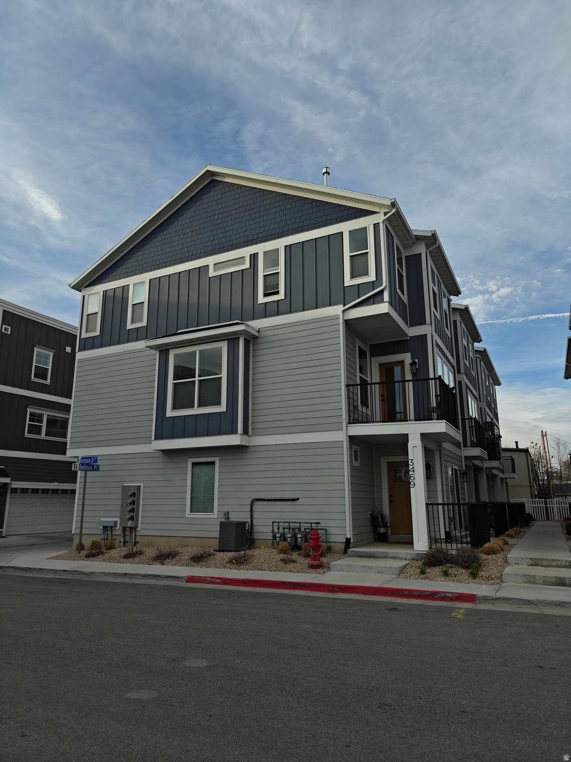 Unobstructed south-facing views and exceptional natural light. This floorplan contains a spacious open main level, oversized kitchen with large island seating, 2-car garage, and convenient access to shopping, dining, TRAX, freeway entrances, downtown, and the airport. Completed in December 2022 as one of the first homes in the community, this unit includes numerous builder upgrades that were no longer standard in later phases, including quartz countertops, upgraded soft-close cabinetry, designer tile flooring, tiled laundry and bathrooms, tiled owner's shower with euro glass door, contemporary electric fireplace with floor-to-ceiling shiplap, stair accent lighting, black accent hardware package, premium carpet with memory foam pad, Wi-Fi garage opener, water softener rough-in, and gas line to the deck. Additional owner upgrades include a professionally finished garage with epoxy flake flooring, painted walls, and ceiling-mounted storage racks. Outdoor living spaces include a main-level balcony and ground-level patio. With 9' ceilings, upgraded finishes throughout, and abundant natural light, this early-phase home offers features and quality rarely found in newer units in the community.
