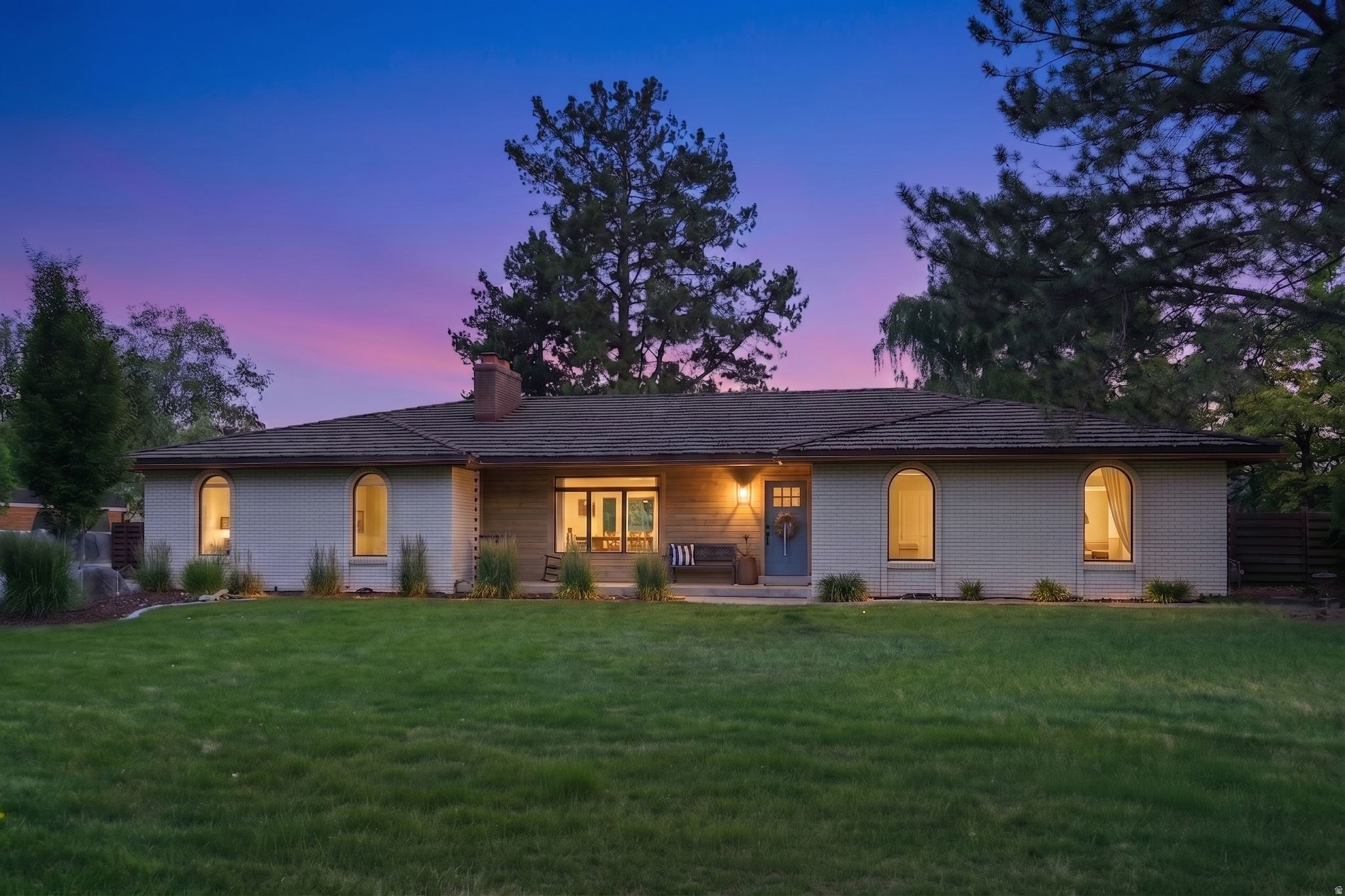 Step into this fully renovated Pepperwood rambler, where modern elegance meets timeless design in one of Sandy's most desirable gated communities. Completely reimagined in 2017 and meticulously updated ever since, this home features a bright, open-concept floor plan with designer finishes, clean lines, and effortless livability throughout. The heart of the home is the expansive great room, anchored by a stunning stone fireplace and surrounded by large windows that fill the space with natural light. A beautifully remodeled kitchen offers sleek cabinetry, premium appliances, a generous island, and seamless flow into the dining area and living space-perfect for entertaining and everyday life. A spacious primary suite provides a quiet retreat, complemented by additional bedrooms and updated bathrooms that feel fresh and thoughtfully curated. The lower level extends the living area with flexible space for media, recreation, guests, or a home gym-whatever your lifestyle calls for. Step outside to an extraordinary backyard retreat featuring expansive lawn space, mature landscaping, fruit trees, multiple patio areas, and exceptional privacy rarely found in today's market. Whether hosting guests or enjoying a quiet evening outdoors, this setting is truly unforgettable. Residents enjoy resort-style amenities including a gated entrance, swimming pool, clubhouse, pickleball courts, tennis courts, walking and biking trails, playgrounds, and community events. Located within the highly desirable Lone Peak, Indian Hills, and Alta school boundaries and just minutes from world-class skiing, hiking, shopping, dining, and commuter access. For added convenience, the home may be available fully furnished with an acceptable offer, creating a rare turnkey opportunity. Rarely do fully renovated ramblers on lots of this caliber become available in Pepperwood. A unique opportunity to enjoy luxury living in one of Sandy's most sought-after communities.