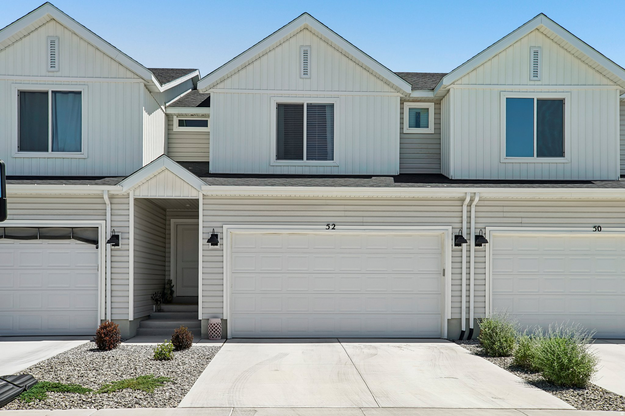 Enjoy low-maintenance living in this nearly new townhome ideally located with beautiful mountain views and convenient access to shopping, dining, schools, and outdoor recreation. The spacious primary suite offers plenty of room to unwind and features two walk-in closets for exceptional storage. The bright, open-concept floor plan seamlessly connects the family room and kitchen, creating an inviting space for gatherings and everyday living. A kitchen water purification system is already installed and included with the home, adding extra value and convenience. This move-in-ready home combines comfort, style, and a fantastic location.