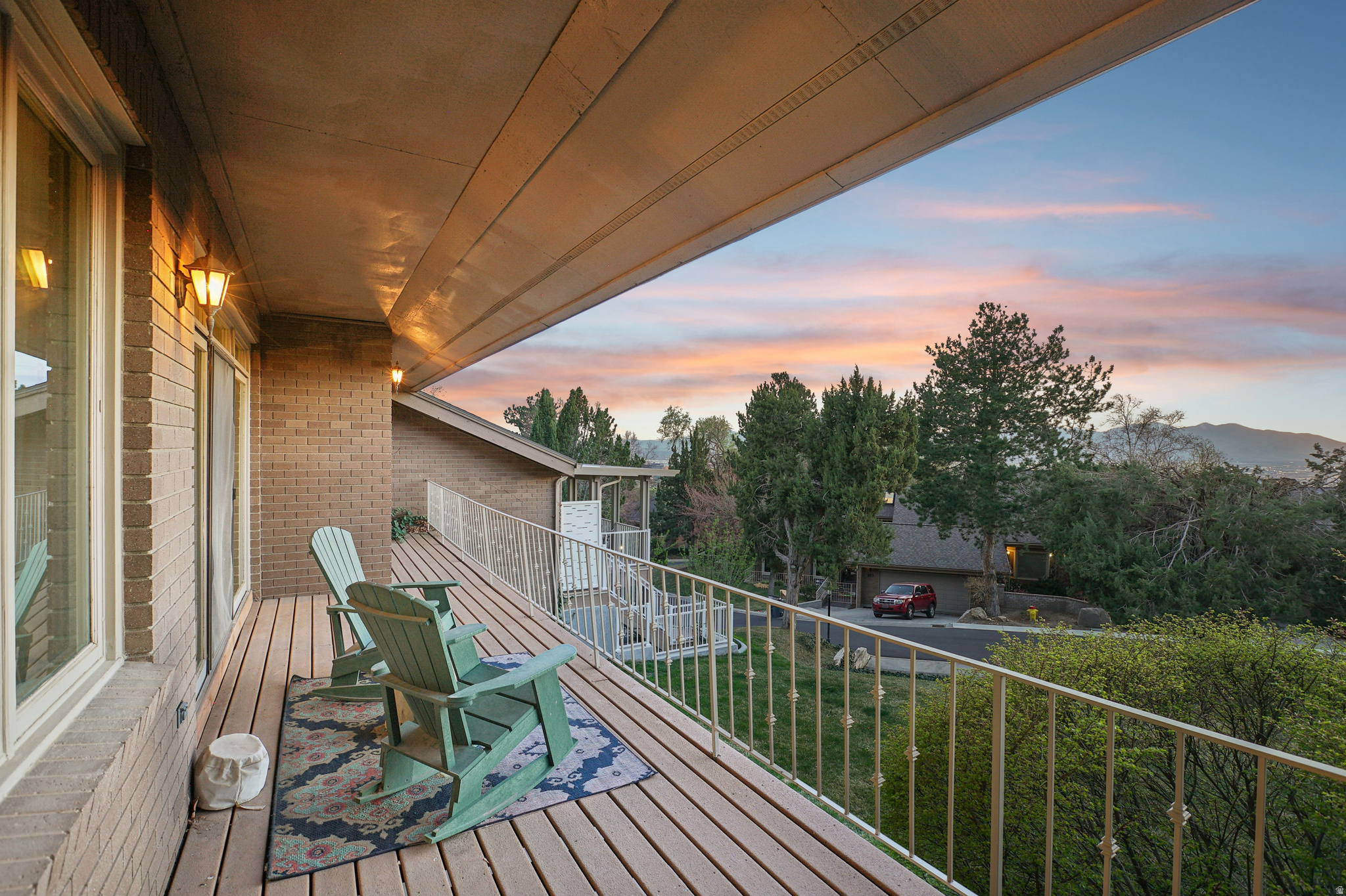 Perched high in the coveted Upper Avenues-above the inversion-this beautifully updated end-unit residence delivers what few homes in Salt Lake City can: million-dollar views of the Oquirrh Mountains and The Great Salt Lake, along with unforgettable sunset panoramas that flood the home with light and color every evening.  Located in a private, gated community, this home combines the ease of main-floor living with the space and flexibility of a fully finished walkout lower level-offering the feel of a single-family residence without the maintenance.  Step inside to a grand, light-filled entry with vaulted ceilings and skylights, leading into refined living spaces designed to showcase the views at every turn. The formal living and dining areas open to a covered deck where the valley stretches endlessly below and the Oquirrh range rises in dramatic contrast-a daily backdrop that never gets old.  The thoughtfully updated kitchen features stainless steel appliances, modern finishes, and a cozy dining nook that flows seamlessly into an inviting family room with a fireplace and access to a charming brick patio-perfect for indoor-outdoor living.  The main-level primary suite offers comfort and privacy, with stunning views, along with a walk-in closet and dual vanity, while a second bedroom-ideal as a home office-adds flexibility. Downstairs, the expansive walkout level includes three additional bedrooms, a den, game room, workout room, and abundant storage, all opening to a private patio and green space.  This is where lifestyle meets elevation-literally. Enjoy cleaner air, sweeping views, and peaceful surroundings just minutes from downtown, the University of Utah, Salt Lake International Airport, City Creek Canyon, and world-class trails.  Homes with this combination of views, privacy, and location rarely come available. Schedule your private showing today and experience what it means to live above it all.