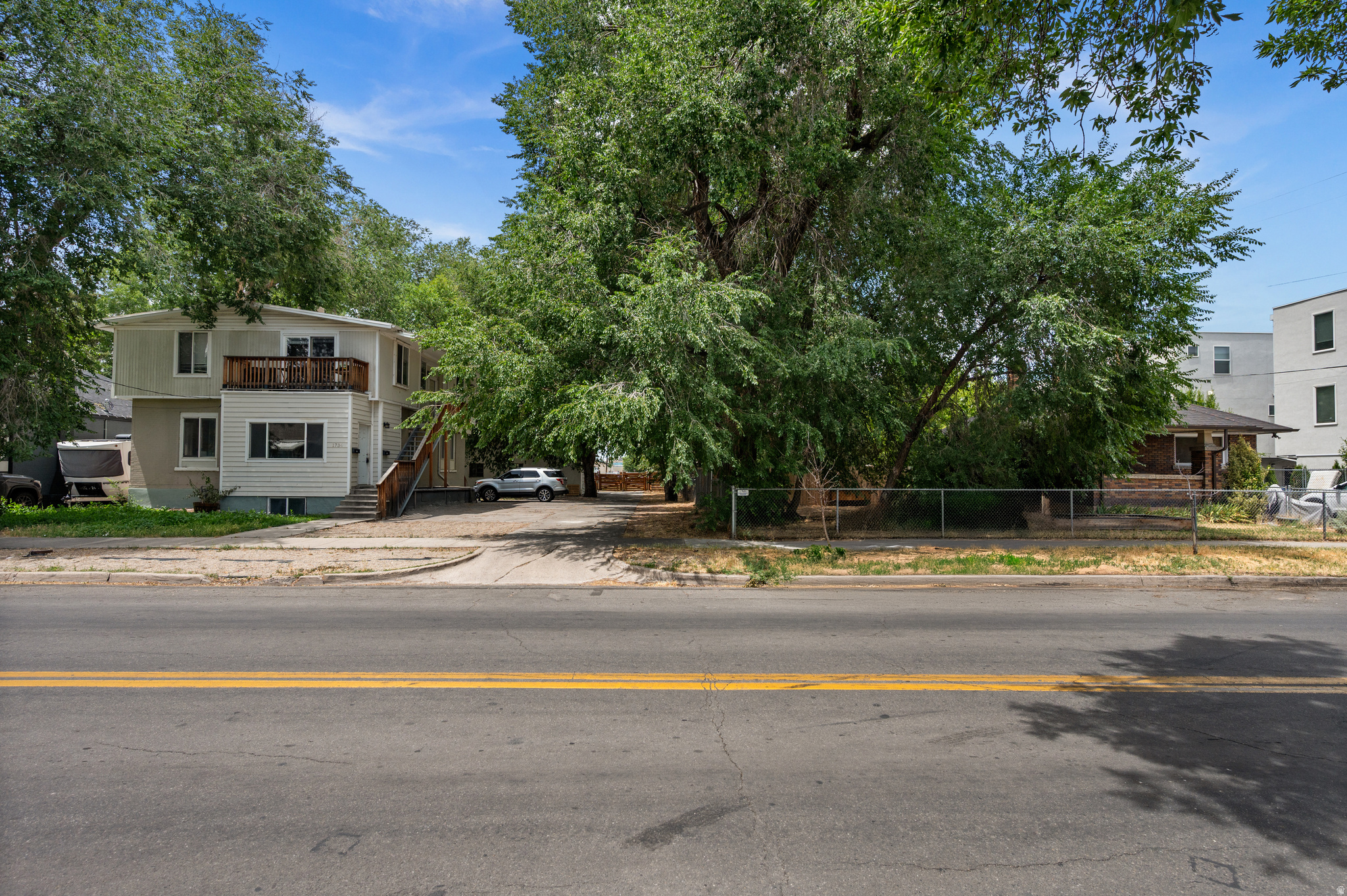 ** Property for sale includes two parcels (1720 S & 1734 S West Temple) totaling 0.48 acres **  You've found the impossible: nearly a half acre of land in a prime SLC location ripe for multi-family development, either for sale or for rent.  MU-5 zoning is already in place, with no historic preservation restrictions.  The property is two contiguous parcels, each 0.24 acres.  One parcel has a 1,700 SF single-family home with 3 beds, 2 baths and a small one car garage.  The other parcel has a 2,935 SF up/down duplex with a two car garage.  All three units currently have tenants, so the property can continue to generate income while you prepare plans and obtain permits.  It's no secret that parts of the Ballpark are still pretty darn gritty.  This part isn't.  It's a lovely tree-lined stretch of West Temple, nestled between one of the Ballpark's most successful residential developments (the EDITH, with recent sales in the $500K to $600K range) and a few well-kept single family homes.  It's a perfect spot for new multifamily development, whether you're interested in building upmarket offerings or more affordable units.
