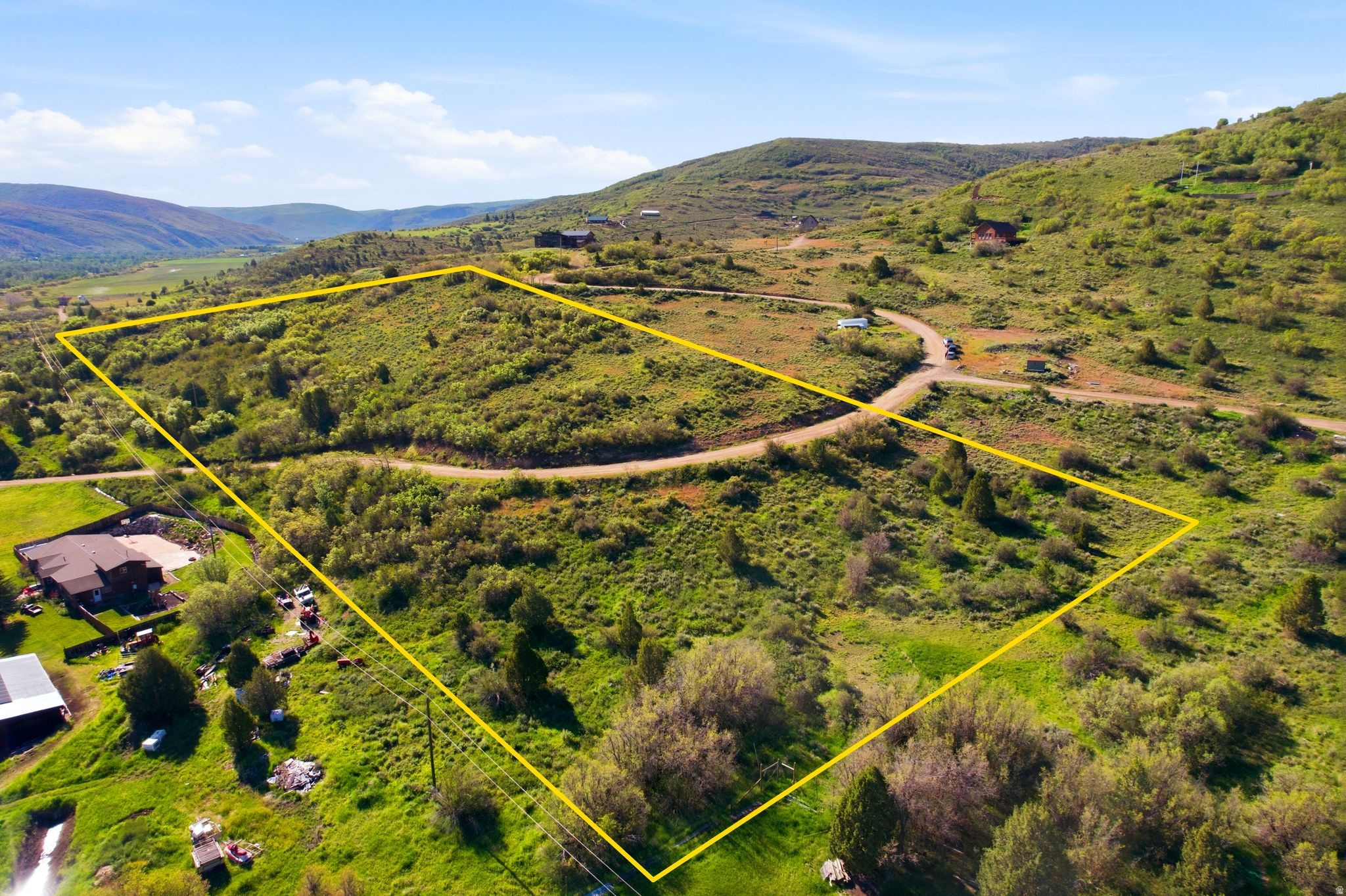 If you've been looking for a private, peaceful area to build your new home, you've found it. This 6.2 acre property is located in the gated community of Woodland Estates. Just 6 miles from the quaint town of Kamas, this year round lot is near the mouth of Wolf Creek Pass, the Upper Provo River, and the Uinta Mountains. In approx. 15 minutes you can access Heber City restaurants and shopping. Approx 25 minutes, you can enjoy Park City's world class ski resorts, restaurants, shopping, and nightlife. This location couldn't be more perfect for someone who wants to a peaceful home in the mountains, but also wants to enjoy modern amenities. Gradual slope with amazing views of the Wasatch back and Kamas Valley.  This property comes with a survey and perc feasibility letter/septic design on file.