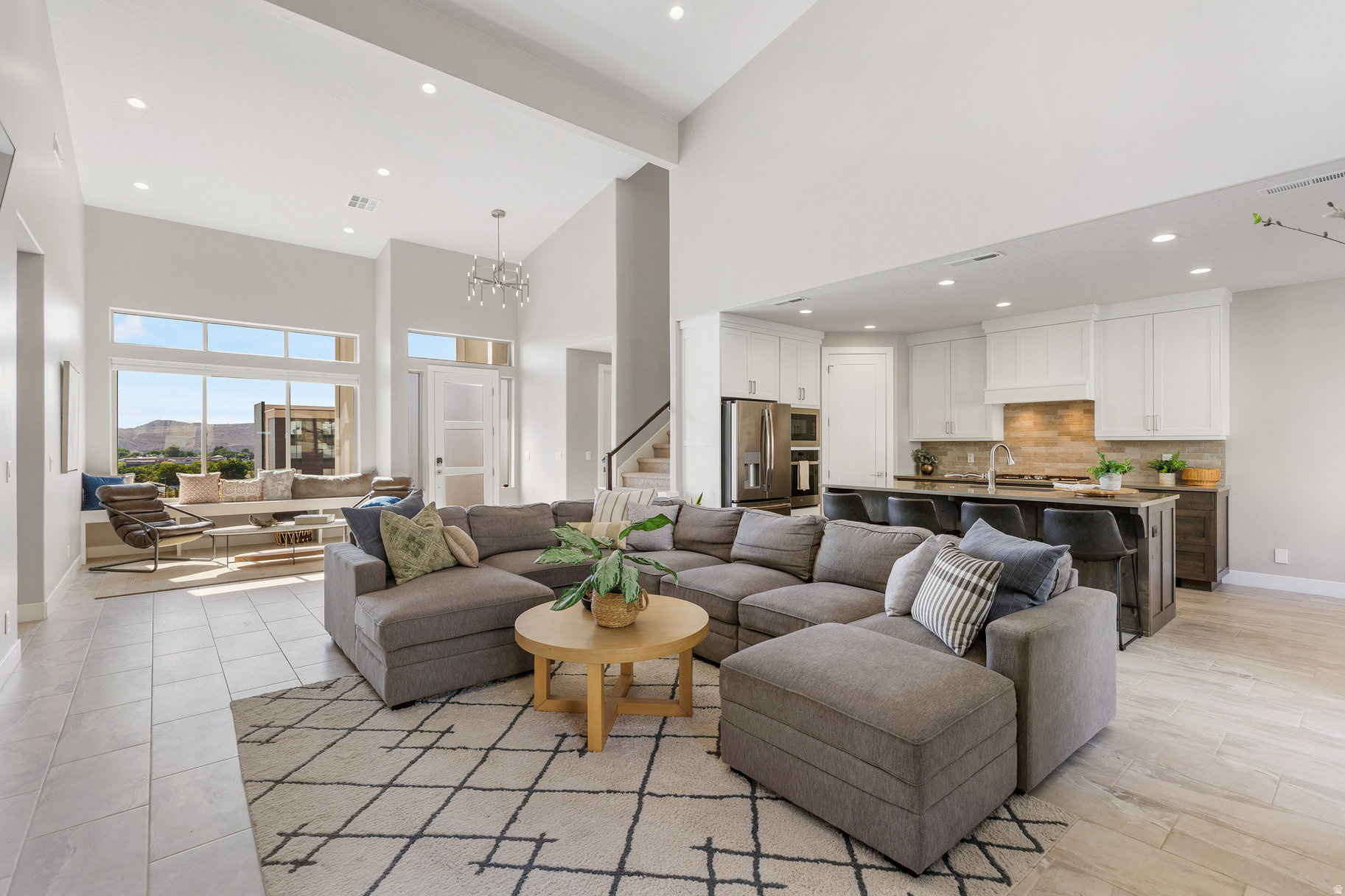 Perched in a brand-new subdivision with sweeping views of Pine Valley, this spacious, modern home blends style, comfort, and functionality. Thoughtfully designed with full landscaping, rock retaining walls, and an elevated setting, it offers a true "wow" factor from the curb to the upper-level deck. Inside, the kitchen shines with floor-to-ceiling soft-close cabinets, quartz countertops, porcelain tile backsplash, walk-in pantry, and high-end GE Profile appliances-including a WiFi-enabled oven, GE fridge, and Whirlpool dishwasher. Nine-foot ceilings, a pullout double garbage bin, central vacuum and smart storage add to the convenience. The living room boasts 19-foot vaulted ceilings, a stone gas fireplace that stretches to the ceiling, and dual 8-foot sliding doors that fill the space with light. Upstairs, a 24'x8' covered deck offers an incredible perch to take in Pine Valley's beauty. The primary suite includes a sliding glass door to the backyard, a soaking tub, walk in closet and walk in shower. The entry has transom windows and a cozy sitting area with a built-in window seat, while the 8-foot front door with privacy glass and a Schlage keypad lock sets a modern tone. All closets include built-in shelving, blinds are installed throughout, and the oversized 3-car garage offers extra-tall 11 foot four inch ceilings for maximum storage. An owner's closet with a locked door adds flexibility for part-time or rental use. With its prime location close to Zion and unmatched views, this home is ready to impress. The home is a short drive to the sheer massive cliff walls of Zion National Park, the hoodoos of Bryce Canyon National park, or the North Rim of The Grand Canyon. There is no place like it. Enjoy nearby hiking, biking, and outdoor adventures or any of the 4 amazing large reservoirs and thousands of recreational public acres for the adventurous at heart. The region is also known for its internationally renowned golf courses that recently hosted the PGA tournament and will soon host the LPGA. Saint George is also the host for many events such as the Ironman, Red Bull Rampage, and the Saint George Marathon.All information herein is deemed reliable but is not guaranteed. The buyer is responsible to verify all listing information, including square feet/acreage, to the buyer's own satisfaction.