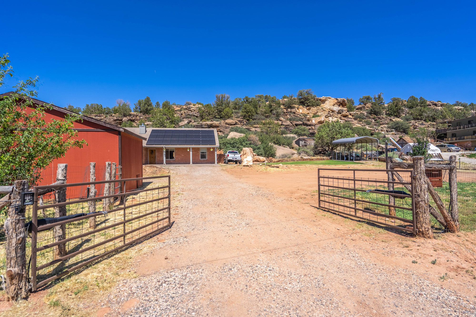Some properties just stop you in your tracks. This horse property is one of them. Tucked into the rolling hills with sweeping mountain views, this extraordinary property delivers a lifestyle that is genuinely rare in Southern Utah. Whether you are dreaming of self-sufficient living, a peaceful retreat, or simply more space to breathe, everything you need is already here and waiting. The land itself is a standout. A thriving orchard of 13 fruit trees produces fresh homegrown harvest throughout the year, joined by sprawling blackberry bushes and a grapevine that make every season worth celebrating. A fully enclosed chicken house, a storage shed, and a 14 x 24 barn with partial enclosed locked storage round out an outdoor setup that is as functional as it is charming. Energy independence comes built in with 27 fully paid solar panels, delivering meaningful savings from day one. A gated entry provides the privacy and security that a property like this deserves. For those who love their toys and their tools, the extra large finished and insulated garage offers serious workspace, while a 20 foot height RV carport with its own concrete pad and separate driveway keeps your recreational vehicles sheltered and ready for adventure. This is not just a home. It is a way of life.