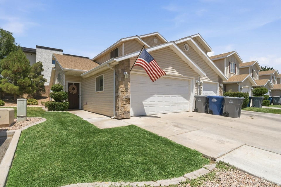 Well-maintained end-unit home in Pecan Meadows, offering one of the largest private backyards in the community with adjacent common yard space along the side for added openness and privacy. Inside, you find vaulted ceilings and a sliding glass door that create a bright and open feel, while painted cabinets and stainless steel appliances bring a clean, modern touch to the kitchen. Ceiling fans in every room add comfort throughout the home. The main-level primary suite features a walk-in closet and private bath with double sinks. Upstairs, you'll find a full bathroom for the additional two bedrooms. A spacious 2-car garage includes built-in wood shelving for convenient storage. Enjoy low-maintenance living with exterior insurance and yard maintenance covered by the HOA. With its exceptional private yard, garage space, end-unit setting, and thoughtful upgrades, this home is a standout opportunity in the heart of Hurricane. Freezer in the garage is excluded. Buyer to verify all information, deemed reliable, however buyer to verify all info including utilities, rental restrictions, and HOA information if applicable.