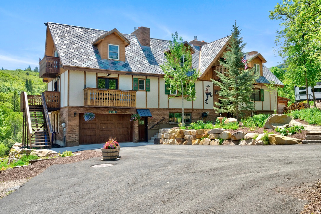Some properties are simply hard to categorizeand that's exactly what makes this one special. Nestled into the mountainside of Eden's Ogden Valley, this Swiss chalet inspired retreat lives first and foremost as a warm, character filled family home, with the rare added bonus of two income producing guest suites already in place. Whether you're drawn to the idea of a primary mountain sanctuary, multi-generational living, or a property that could help pay for itself, this one was built for all of it. The main home welcomes you with soaring prow windows, rich natural light, and the kind of mountain soul that can't be designed from scratch. A wood burning fireplace with cast iron insert anchors the main living space, joined by two additional gas fireplaces throughout the home for year round warmth and ambiance. Tall chimneys, sweeping decks, and a distinctive chalet roofline give the exterior an unmistakable presence, while inside, thoughtful modern updates consist of renovated kitchens, updated bathrooms, and quality finishes that bring it comfortably into the present without losing an ounce of character. Step outside and the nearly acre of mountain terrain unfolds around you. A natural spring feeds a gentle stream through the backyard, flowing into two serene ponds. A life size chessboard, a cozy firepit area, an eight person hot tub, and panoramic views of the surrounding peaks make this outdoor space as livable as the home itself. Mature trees, thoughtful xeriscaping, a fully stocked woodshed, and generous parking including a garage and additional parking for up to four vehicles.This is truly a home that feels genuinely loved and cared for and is move in ready. For extended family or guests, the two attached suites offer something increasingly rare, true independence within a shared property. The east side suite above the garage is accessed by its own private entrance, features an open concept living, dining, and kitchen area, bathroom and laundry, along with an upper floor bedroom. This can be a fully functional retreat with its own distinct cottage personality, while also being attached and accessible from the main home. The lower suite at basement level offers its own private front and rear entrances, an open concept living and kitchen space with beautiful mountain modern updates, flexible sleeping accommodations, bathroom, laundry and mudroom. This could be equally suited for in laws, adult children, long term tenants, visiting guests or others that come to mind.  For those with an eye toward income, both suites are operating under an existing grandfathered Bed & Breakfast Conditional Use Permit. Furnishings are all negotiable, with the opportunity of a turnkey sale for a buyer ready to hit the ground running. Located minutes from Powder Mountain and Pineview Reservoir, with year round recreation at your doorstep. This is the property you call about because you're curious and end up buying because it feels like home. Square footage figures are provided as a courtesy estimate only and were obtained from county records. Buyer is advised to obtain an independent measurement. Buyer and Buyer's Agent to verify all information, which has been provided as a courtesy only. All information is deemed reliable but not guaranteed.