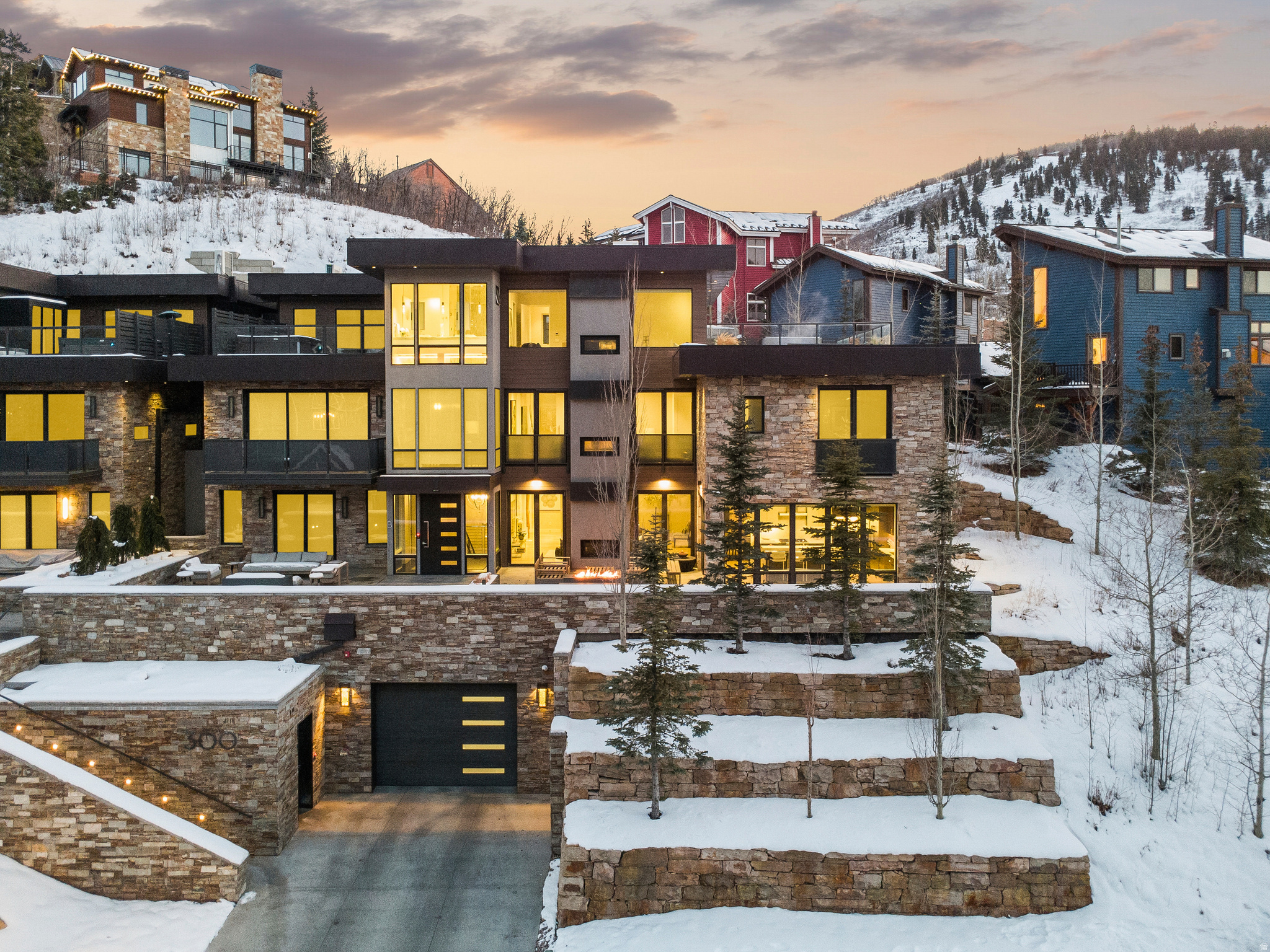 300 Deer Valley Drive Residence A presents a rare offering to own one of only four Roundabout homes meticulously designed by Constantino Grandjaquet, one of Utah's premier contemporary architects. Perfectly situated just outside the incredible energy of historic Main Street, Park City, and lower Deer Valley, you are just moments from hitting the slopes at both Park City Mountain Resort via the Town lift and Deer Valley Resort at Snowpark Lodge. Every detail has been considered by the homeowners who curated a home in high style and exquisite taste, offering a thoughtful layout with top-shelf finishes and smart details. This bespoke retreat is for the most discerning Buyer who values the unique beauty of the area, ease of access to multiple ski resorts, luxurious comfort, and the opportunity to own a home in one of the most sought-after mountain destinations in the world. Residence A is the largest of the four homes at Roundabout, measuring just under 5000 SF, offering 4 bedrooms and 5 baths, and private garage space for 4 cars, a rare offering in Old Town. But this glamorous home is not about size and scale. The refined details present layers of texture and warmth, and the WOW factor. A chef's kitchen offers high-end appliances, 2 sinks, 2 dishwashers, gorgeous cabinetry, a walk-in pantry with a coffee station, and doors that open onto one of several terraces in the residence. The dining area reflects the owner's exquisite taste, offering two full-sized Thermador wine coolers built into a gorgeous credenza with inlaid Italian glass. The adjoining great room opens onto a terrace and has a fire feature perfect for entertaining 12 months of the year. The Main Floor laundry room is stunning as is the powder room, complete with Cristallo Quartzite countertops. The floor plan is effortless, and all 4 floors are serviced by an elevator. The luxurious primary suite is on the top floor, has a deluxe walk-in closet with laundry, a spa-like bath with steam shower, a sleek fireplace,floor-to-ceiling windows, a private rooftop terrace with a luxury hot tub and fire feature, which is the perfect place to view endless sunsets over Old Town Park City. Additional notable features and amenities include: a study with mood lighting and Phillip Jeffries wall covering, a lounge/spa with walnut slab wall accents, a beverage cooler, and an 80" TV. There are 3 fireplaces, a mudroom off the heated garage, radiant heat throughout, including walkways and terraces, AC, Finntech-air filtration system, Lutron control lighting, Audio system, wide plank wood flooring, gorgeous tilework, natural stone, and upgraded gallery, and dimmable lighting. There are so many more features and amenities for this spectacular residence to list. This is a home you will want to experience in person. You are invited!