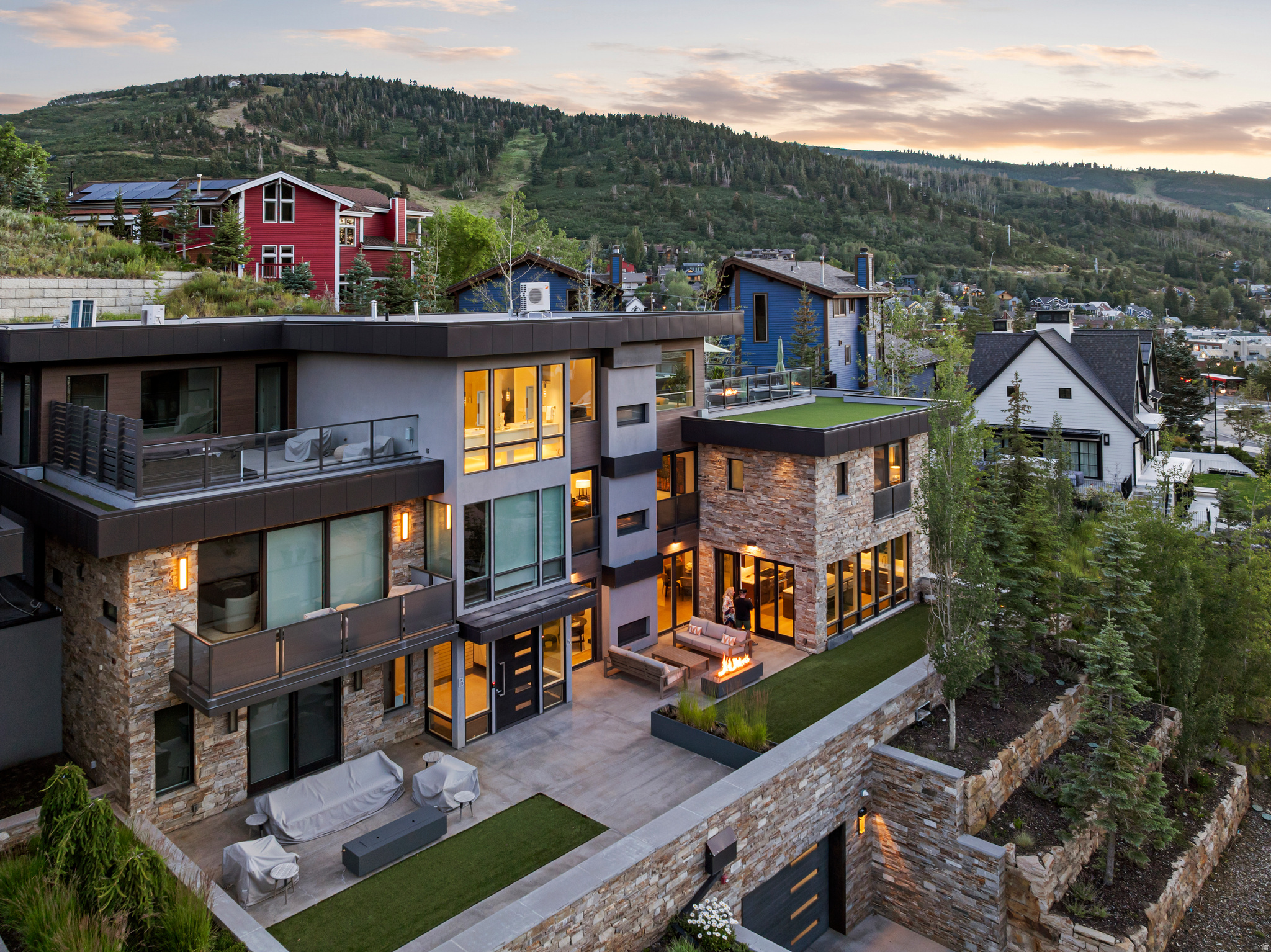 300 Deer Valley Drive Residence A presents a rare offering to own one of only four Roundabout homes meticulously designed by Constantino Grandjaquet, one of Utah's premier contemporary architects. Perfectly situated just outside the incredible energy of historic Main Street, Park City, and lower Deer Valley, you are just moments from hitting the slopes at both Park City Mountain Resort via the Town lift and Deer Valley Resort at Snowpark Lodge. Every detail has been considered by the homeowners who curated a home in high style and exquisite taste, offering a thoughtful layout with top-shelf finishes and smart details. This bespoke retreat is for the most discerning Buyer who values the unique beauty of the area, ease of access to multiple ski resorts, luxurious comfort, and the opportunity to own a home in one of the most sought-after mountain destinations in the world. Residence A is the largest of the four homes at Roundabout, measuring just under 5000 SF, offering 4 bedrooms and 5 baths, and a private 4-car garage, a rare offering in Old Town. But this glamorous home is not about size and scale. The refined details present layers of texture and warmth, and the WOW factor. A chef's kitchen offers high-end appliances, 2 sinks, 2 dishwashers, gorgeous cabinetry, a walk-in pantry with a coffee station, and doors that open onto one of several terraces in the residence. The dining area reflects the owner's exquisite taste, offering two full-sized Thermador wine coolers built into a gorgeous credenza with inlaid Italian glass. The adjoining great room opens onto a terrace and has a fire feature perfect for entertaining 12 months of the year. The Main Floor laundry room is stunning, as is the powder room, complete with Cristallo Quartzite countertops. The floor plan is effortless, and all 4 floors are serviced by a private elevator. The luxurious primary suite is on the top floor, has a deluxe walk-in closet with laundry, a spa-like bath with steam shower, a sleek fireplace,floor-to-ceiling windows, a private rooftop terrace with a luxury hot tub and fire feature, which is the perfect place to view endless sunsets over Old Town Park City. Additional notable features and amenities include: a study with mood lighting and Phillip Jeffries wall covering, a lounge/spa with walnut slab wall accents, a beverage cooler, and an 80" TV. There are 3 fireplaces, a mudroom off the heated garage, radiant heat throughout, including walkways and terraces, AC, Finntech-air filtration system, Lutron control lighting, Audio system, wide plank wood flooring, gorgeous tilework, natural stone, an upgraded gallery, and dimmable lighting. There are so many more features and amenities for this spectacular residence to list. This is a home you will want to experience in person. You are invited!