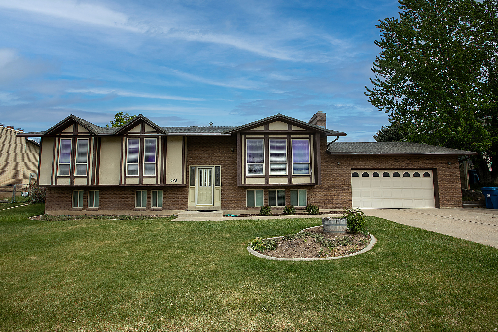 Panoramic Ben Lomond Peak views steal the show from the back deck of this spacious Washington Terrace home. With a desirable south-facing front exposure, 4 bedrooms, 3 baths, and 2,549 finished square feet, this split-entry layout offers bright living spaces, skylight, two fireplaces, a finished daylight lower level, den/office, storage, and walkout access. The fully landscaped and fenced .2365-acre lot includes mature trees, automatic sprinklers, outdoor lighting, a storage shed, and an attached 2-car garage with workbench. No HOA and exceptional mountain and valley views make this home a standout opportunity.