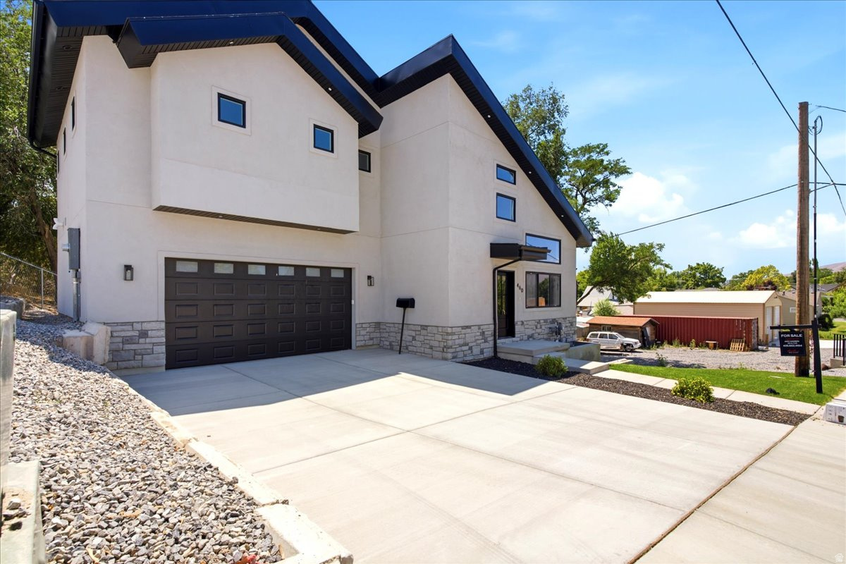 Welcome to this ultra-modern, 2,950-square-foot beautifully designed home for effortless luxury living. Featuring 5 spacious bedrooms and 2.5 stunning bathrooms. This home stands out with its striking vaulted ceilings and seamless, contemporary design. The heart of the home flows beautifully into a bright living space, complete with a charming loft area perfect for a home office or cozy reading nook. Convenience is unmatched with two dedicated laundry rooms--including a private setup integrated directly into the primary suite. Downstairs, a fully finished walk-out basement offering a great room and four private bedrooms. Step outside to your private oasis, where a peaceful, trickling stream runs right alongside the property. Enjoy the outdoors from your choice of a spacious top deck or the shaded comfort of the covered patio below. With low-maintenance landscaping and absolutely no HOA, this exceptional property offers true freedom and modern sophistication. Schedule your tour today!