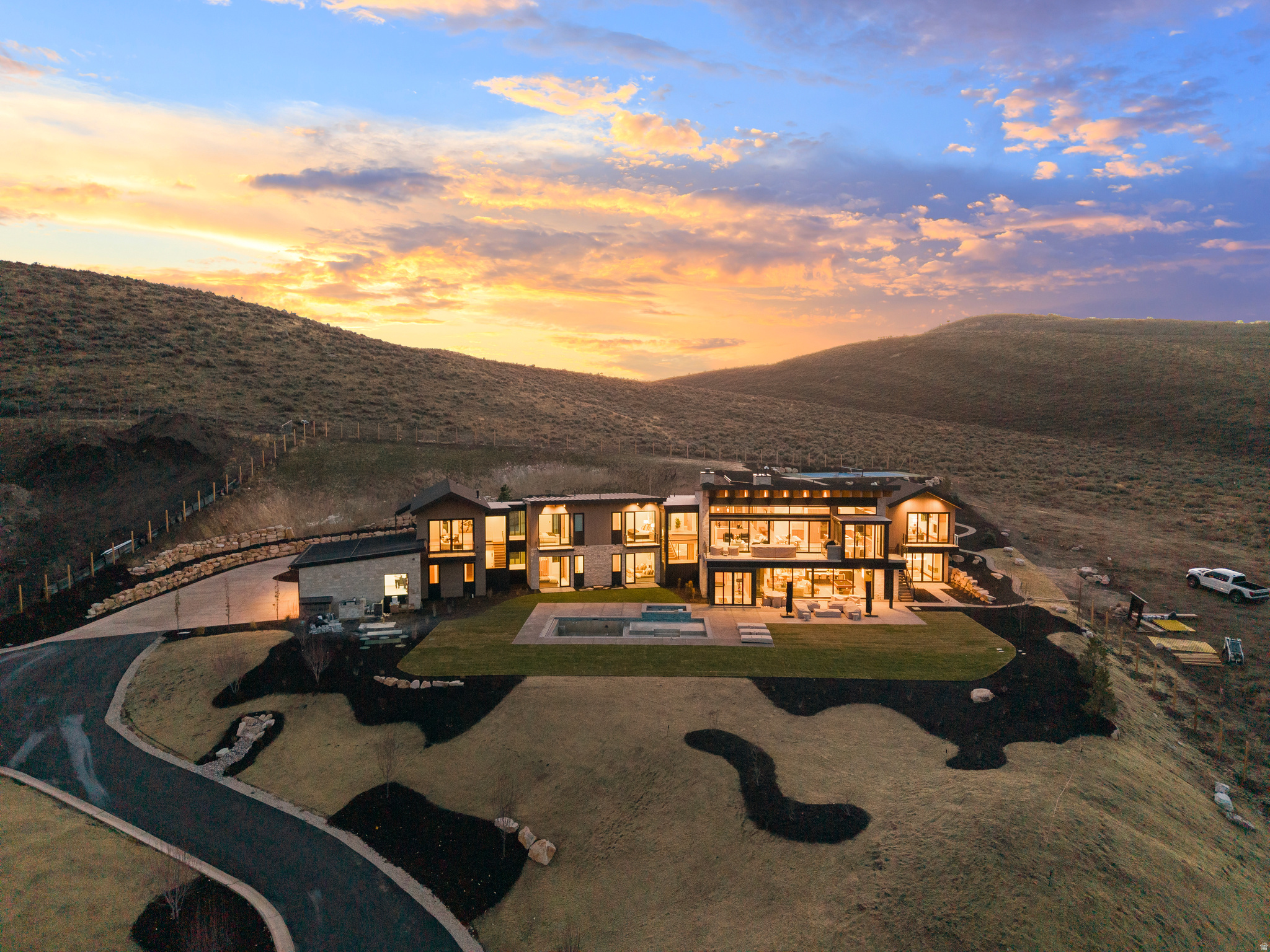 2025-build Old Ranch Rd. wellness estate backing 2,200 acres of Round Valley open space. This luxury estate offers an unparalleled blend of modern design, natural beauty, and convenience. Designed for wellness and entertainment, the home features a state-of-the-art wellness area with a sauna, cold plunge, yoga space, and rubber flooring. Wine enthusiasts will appreciate the 500+ bottle wine cellar with a dedicated tasting area. Floor-to-ceiling paneled slider doors lead to seamless indoor-outdoor living with a private swimming pool, built-in hot tub, pickleball court, walking paths, and tubing hill. Two outdoor fireplaces provide the perfect setting to enjoy the open space and stunning sunsets. The heated courtyard and five-car heated garage, complete with epoxy floors and a fully equipped dog bath, ensure every detail is thoughtfully considered. Technology integrates effortlessly with a Control 4 smart system and electric auto window coverings throughout. Ideally located, this estate is minutes from world-class ski resorts, the trails of Round Valley, and the charming Willow Creek Park. Heber's FBO and Salt Lake City International Airport are both easily accessible, providing convenience for private and commercial travelers alike. This home backs up to the majestic Round Valley - offering 2,200 acres of open space. A rare blend of in-town convenience and and true estate amenities - pool, wellness suite, and open-space backdrop - minutes to skiing and Main Street.