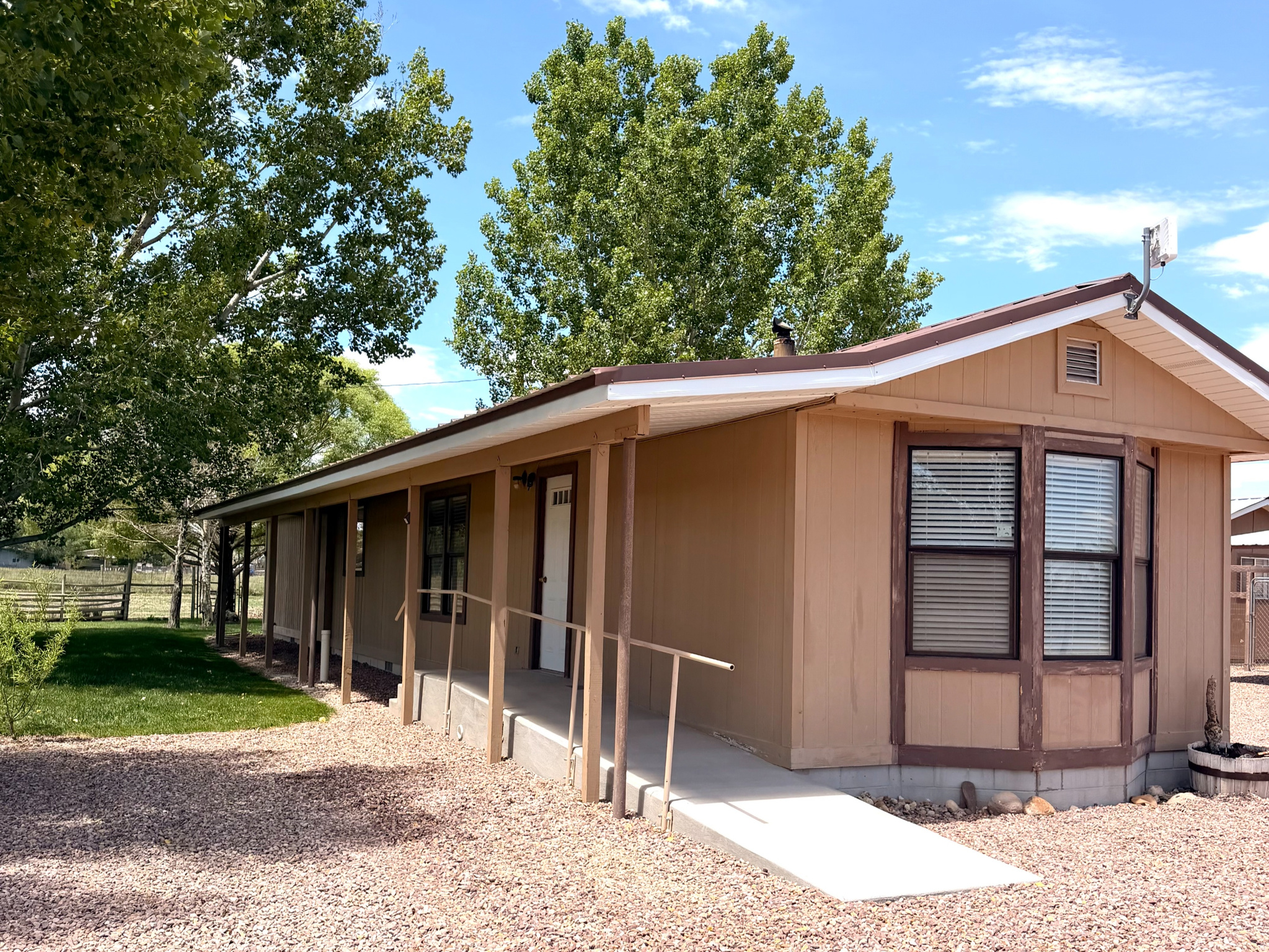 Set on 3 beautifully maintained acres, this property combines the charm of country living with the practical features needed for animals, hobbies, and everyday life. This 2-bedroom, 2-bath home offers a peaceful setting surrounded by mature landscaping and open space. The property is fully fenced and includes a dedicated dog run, making it ideal for pet owners. Horse lovers will appreciate the horse-friendly acreage, while hobbyists, mechanics, or craftsmen will love the heated workshop. Three additional outbuildings provide plenty of storage for equipment, tools, feed, or recreational toys. Whether you're looking for a small hobby farm, space for animals, or simply a quiet place to call home, this property offers endless possibilities.