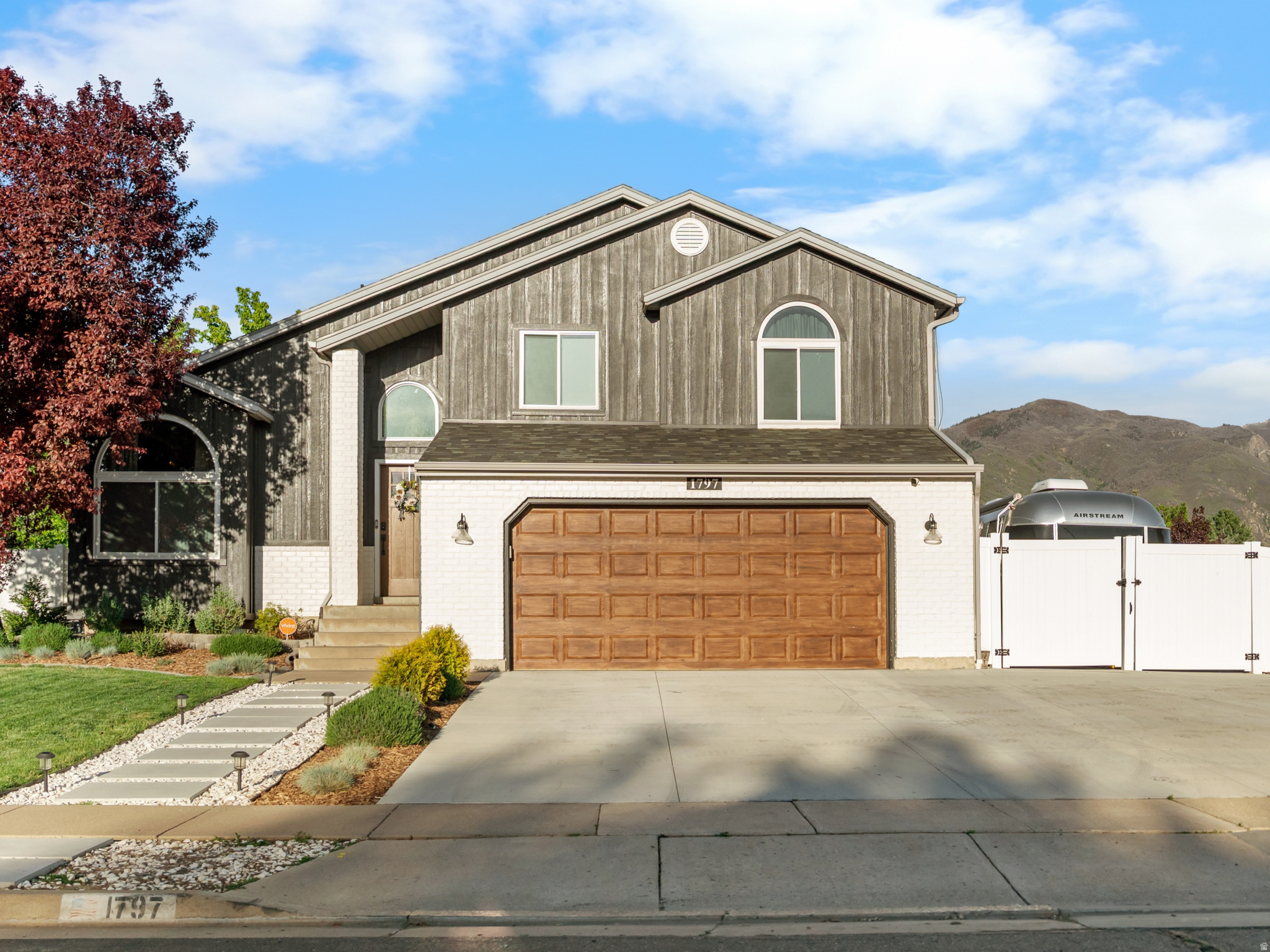 This awesome home has been completely remodeled with major upgrades throughout. A new driveway with gated RV parking, fresh board and batten Hardie board siding, new front landscaping, and a new walkway. Enjoy outdoor living with a private back deck, pergola seating area, and fenced garden with raised beds. Interior highlights include a fully finished basement with a new bedroom, bathroom, laundry room, and additional living space. The home has been updated with new PEX plumbing, tankless water heater, water softener, upgraded electrical panel, and improved HVAC and ventilation. The main level offers an open-concept layout with a remodeled kitchen featuring new cabinetry, quartz countertops, waterfall island, and new appliances. Also included is new flooring, paint, windows (front and basement), doors, lighting, and fixtures throughout. Bathrooms have been fully renovated, and custom touches like built-ins, fireplaces, upgraded closets, and a dry bar add style and functionality. This home is 100% move-in ready with high-end finishes and many thoughtful "behind the scenes" upgrades. Enjoy it now!