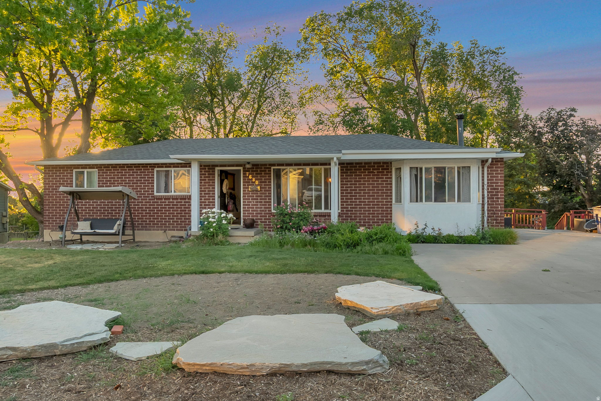 Breathtaking mountain views and an unbeatable location. This rare all-brick rambler offers 5 bedrooms, 2 bathrooms, and endless potential on a spacious .41-acre lot. Just minutes from both Big and Little Cottonwood Canyons, you'll enjoy world-class ski resorts, Fort Union Commerce, shopping and dining, The Shops district, freeway access, and walkability to highly regarded Brighton High School and the local recreation center. Inside, the home features beautiful hardwood floors, granite countertops, and a bright open family room framed by breathtaking mountain views and a cozy wood-burning stove. The oversized backyard is a true retreat, complete with a secluded tiny home perfect for guests, creative space, or a private escape. With ample room to design your dream outdoor oasis or add a private ADU. The spacious downstairs primary suite includes a separate entrance, offering flexibility for multi-generational living, guest quarters, or potential business use. The basement was previously approved for conditional business use and could potentially be reconverted. Recent updates include a new roof, remodeled primary bathroom and laundry room, new washer and dryer, new dishwasher, newer refrigerator, basement plumbing, and recently cleaned drains, wood stove, and ductwork for added peace of mind. A rare opportunity to own a versatile property with stunning views, generous space, and exceptional access to both outdoor recreation, boutique dining, and city conveniences. Square footage provided as a courtesy per county records.