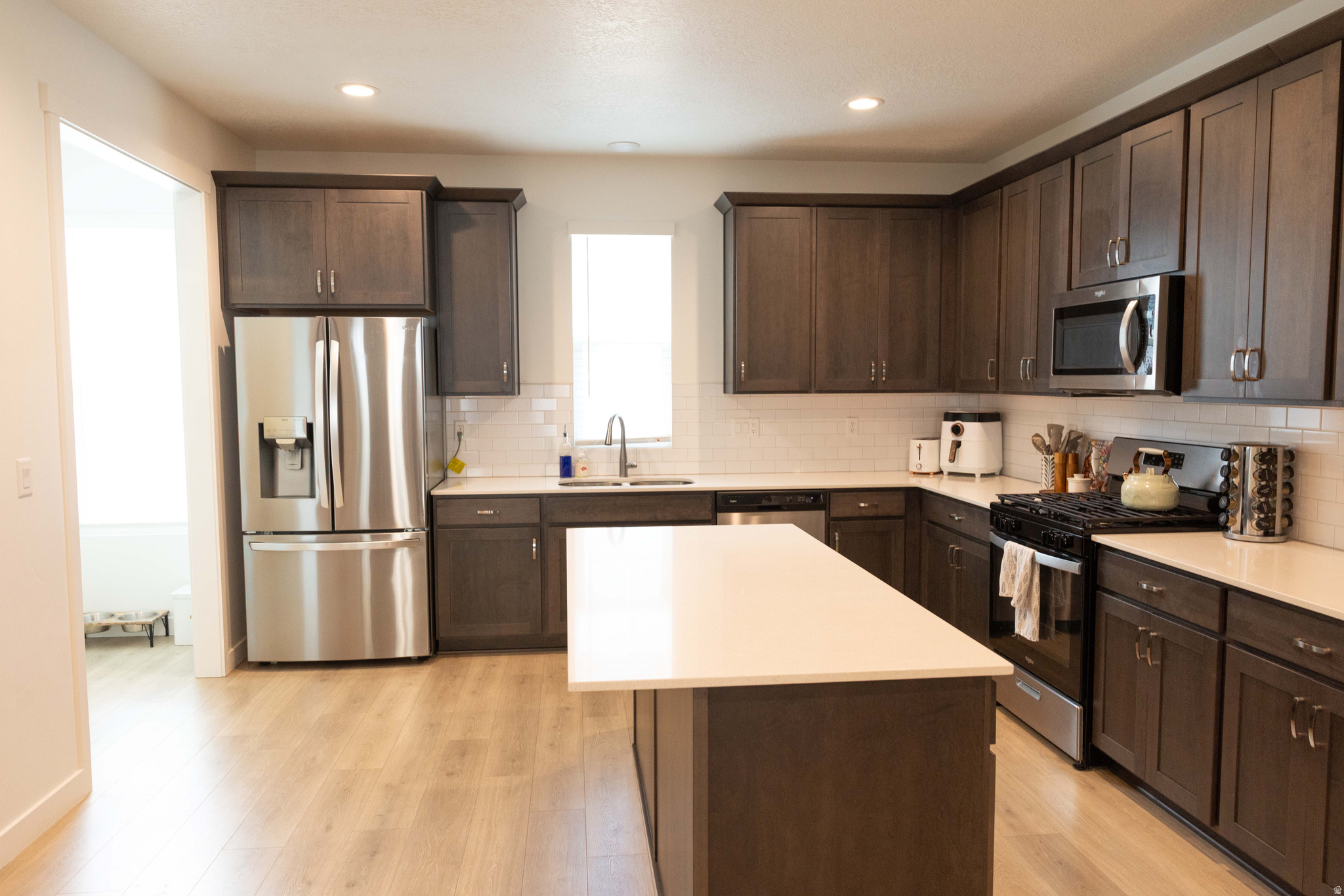 Beautiful townhome with tall ceilings and large windows throughout. Oversized great room with plenty of space for dining as well as living room area, perfect for get togethers or room for a family. Lots of natural light. Master suite with walk in closet and master bathroom. Bonus room on main floor. 2 car garage and additional parking.