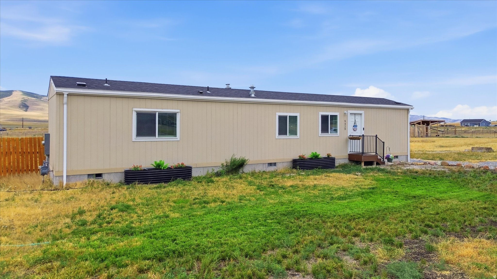 Built in 2023, this 2-bedroom, 2-bath home sits on 2.58 acres with mountain views and no HOA. The open floor plan features wood-tone cabinetry, stainless steel appliances, and a functional kitchen that opens to the living area. The primary suite includes a private bath. The partially fenced backyard offers a fire pit and playground, while the remaining acreage provides room for livestock, gardening, recreational vehicles, or future outbuildings. Located on a quiet cul-de-sac, this property offers the space and flexibility of country living with the convenience of a newer home.
