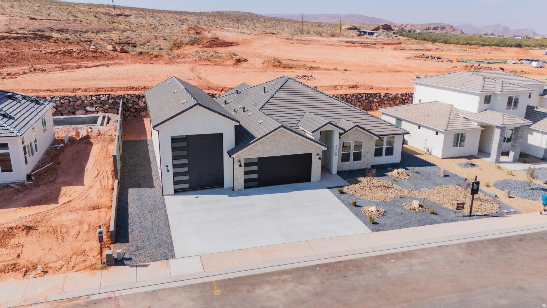 ~Full Custom Home Near Sand Hollow~ Special Pricing! This single level Big Rock Homes home is in the sought-after Sand Hollow Village area blends modern comfort with the ultimate recreational lifestyle. One of the home's standout features is the massive 52-FOOT DEEP RV GARAGE (12' wide x 14' tall door)! Inside, you'll find an open-concept layout with LUXURY FINISHES, spacious bedrooms, and LARGE BACKYARD WITH ROOM TO ADD A POOL! This property comes equipped with premium SMART HOME features including 3 wired in insecurity cameras and a door bell camera. Just minutes from Sand Hollow Reservoir, Sand Hollow Golf Course, the sand dunes, and Zion National Park, you're surrounded by year-round adventure. Additional rear landscaping packages available. Contact listing agent.